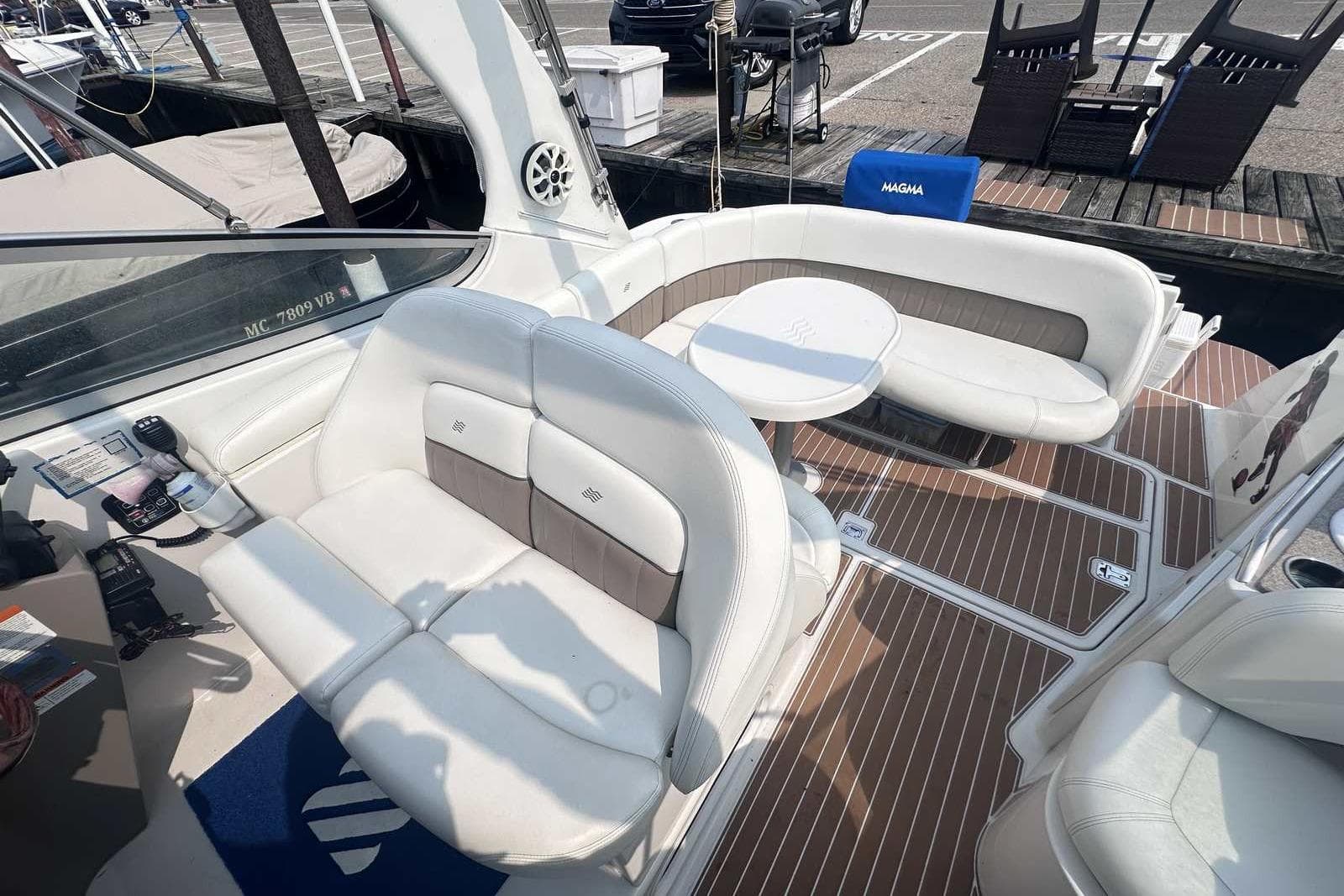 2004 Four Winns 298 Vista boat interior with white seating and wooden flooring.
