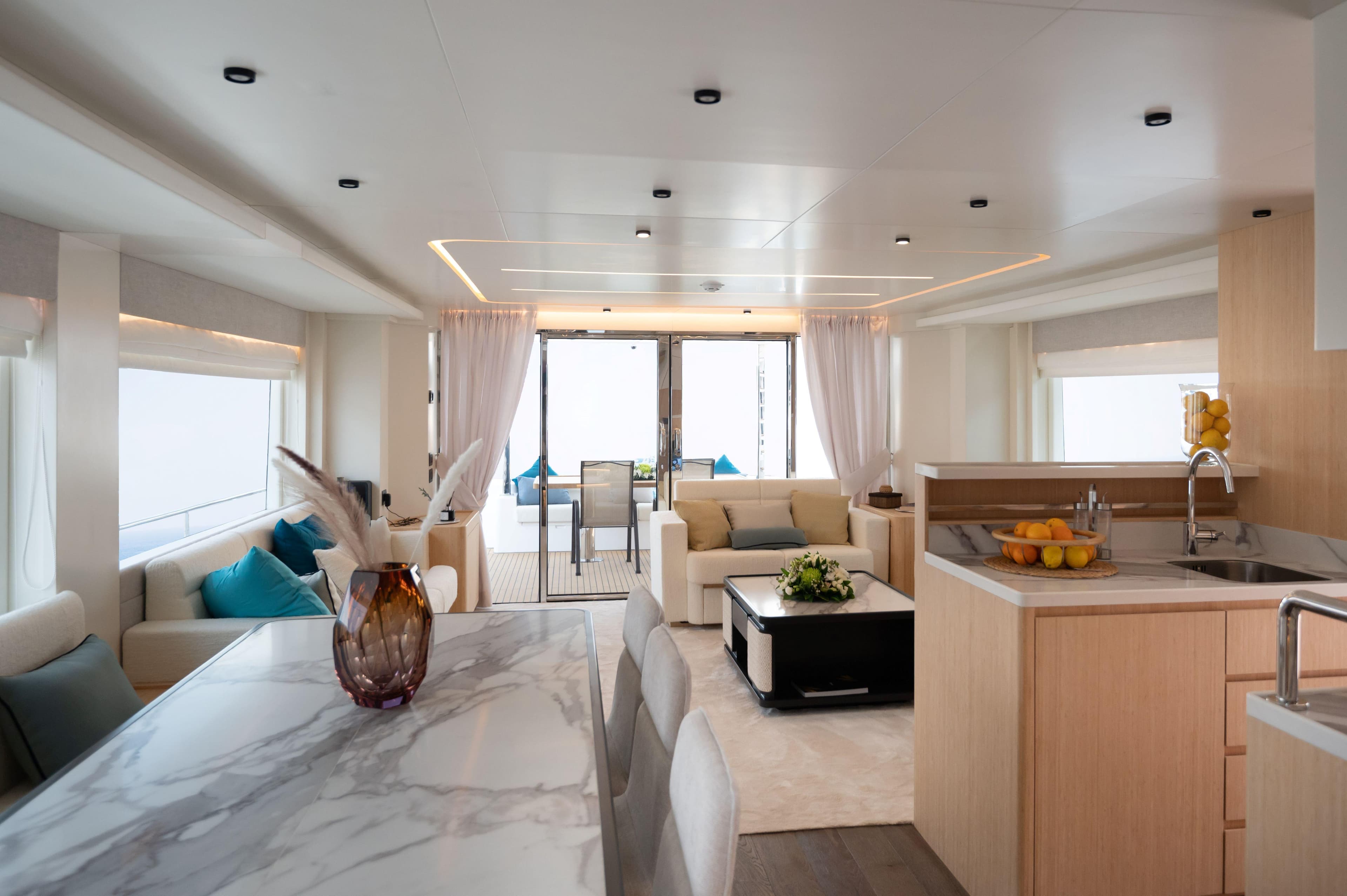Luxurious interior of 2025 Nomad 70 SUV yacht with modern kitchen and elegant seating area.