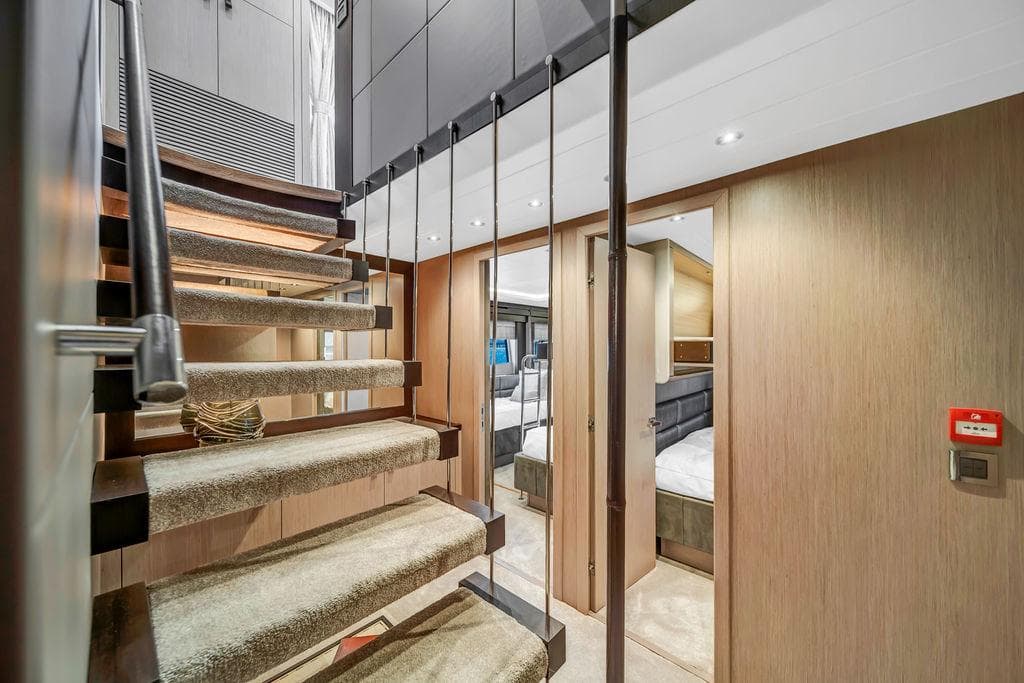 Luxurious interior of 2021 Sunseeker 86 Yacht with modern staircase and elegant cabin design.