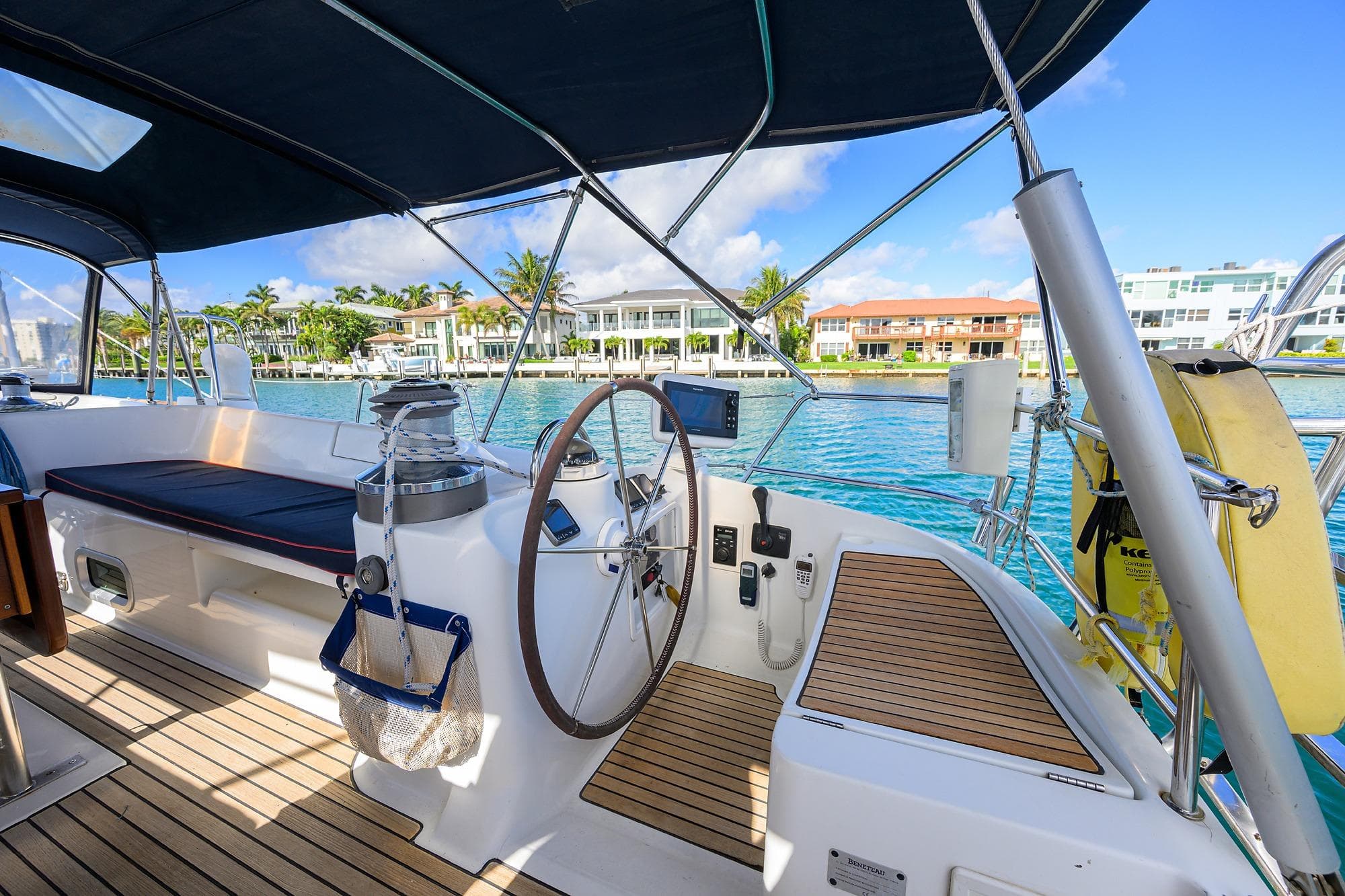 Cockpit of 2003 Beneteau 50 sailboat with waterfront view and modern amenities.