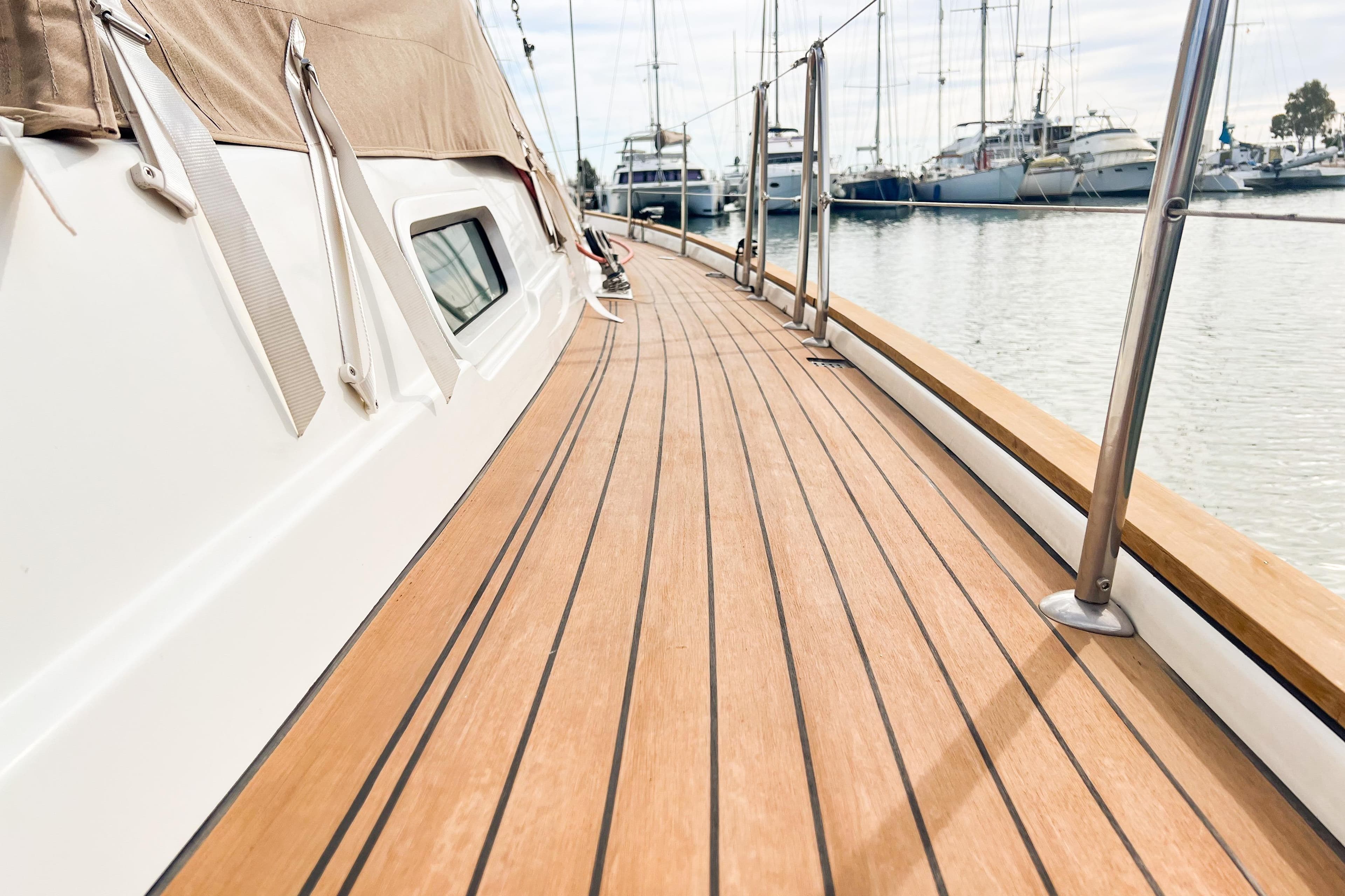 Deck view of a 2004 Beneteau 57 yacht in a marina setting.