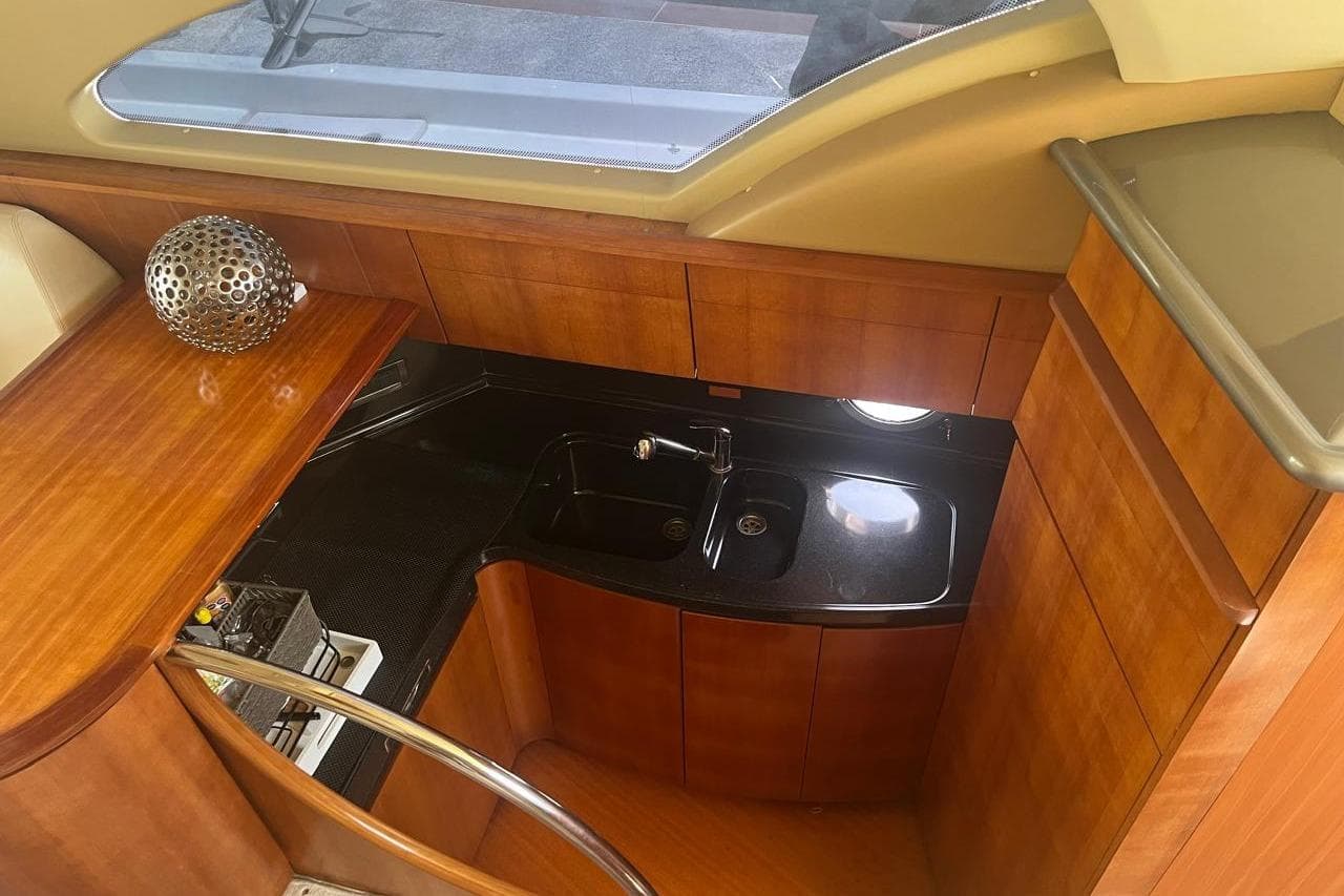 2008 Azimut Flybridge yacht interior with wooden cabinetry and modern sink.