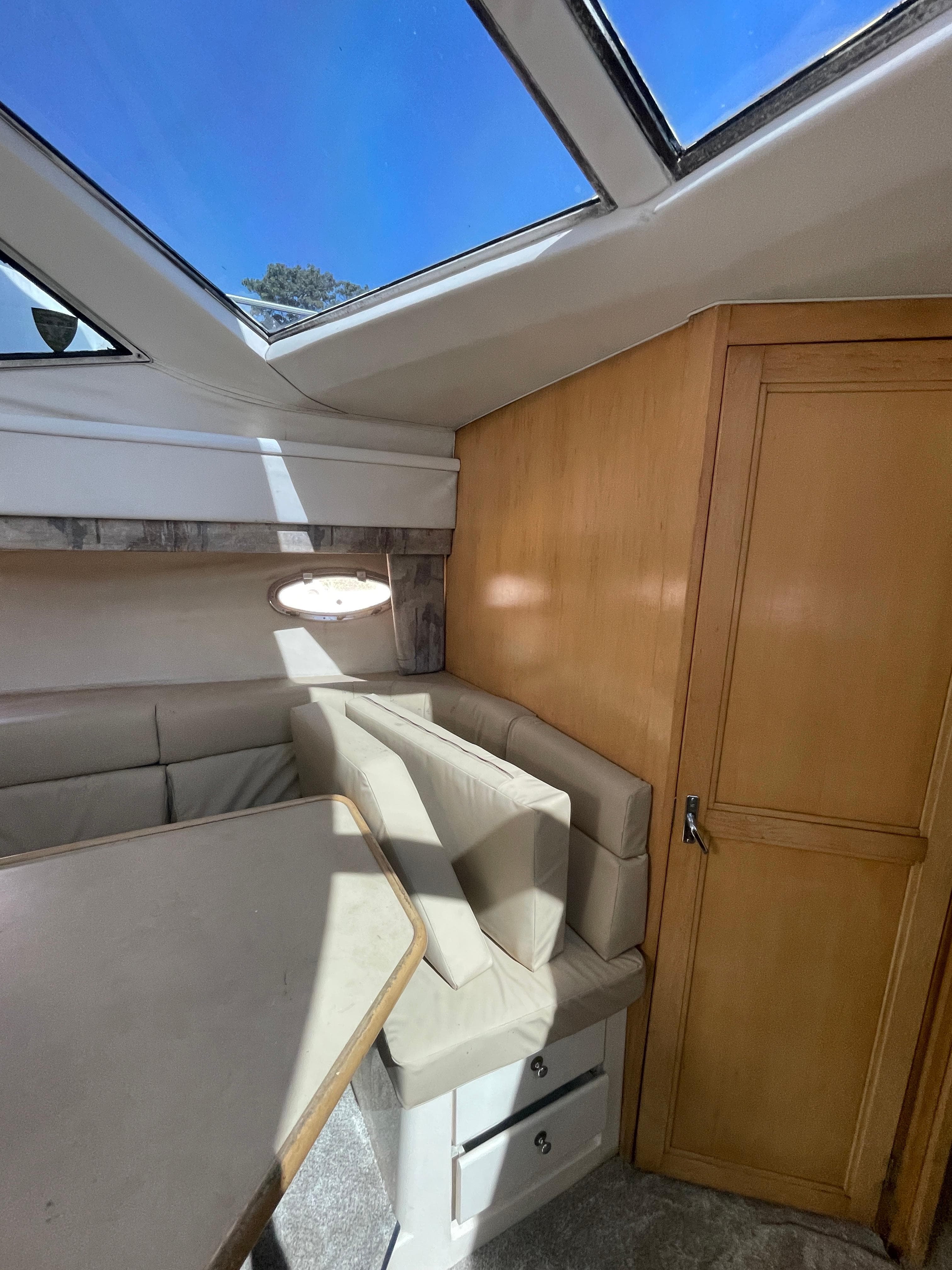 Interior of a 1997 Carver 405 yacht with skylight and seating area.