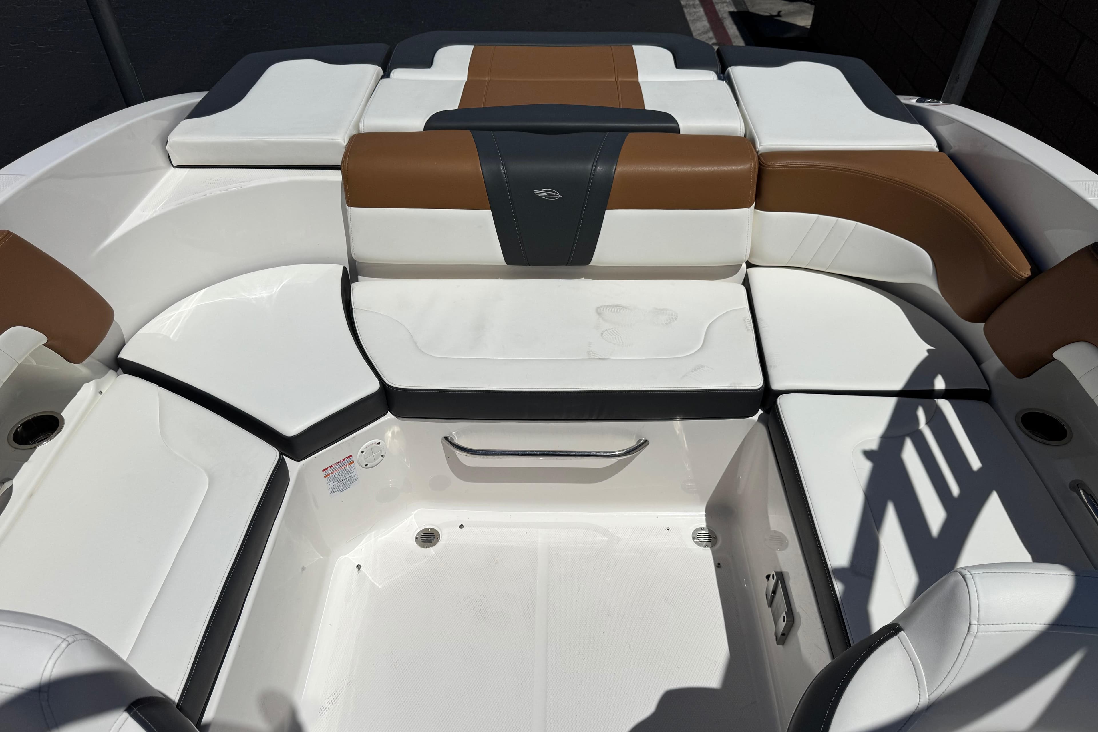 2023 Chaparral 23 SSi boat interior with white and brown seating arrangement.