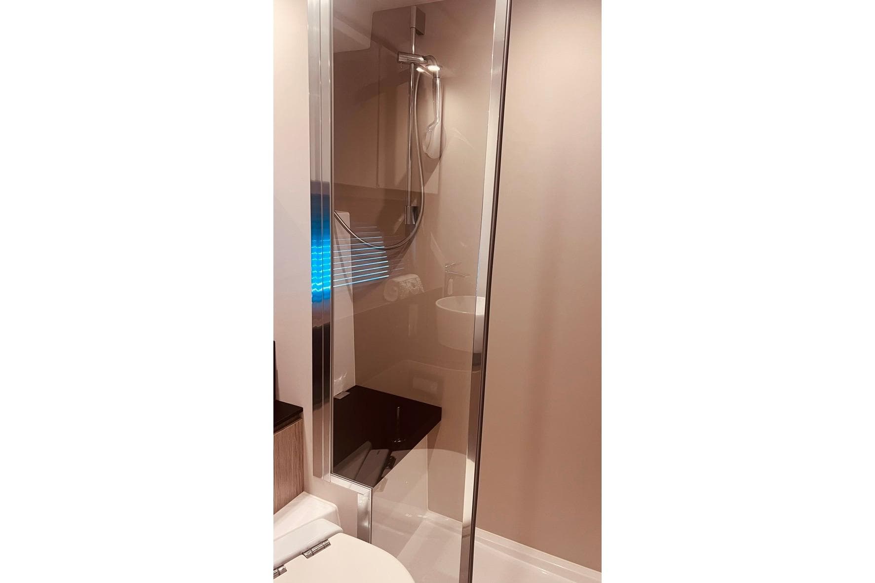 Modern bathroom interior of 2021 Azimut Atlantis 45 yacht with glass shower enclosure.