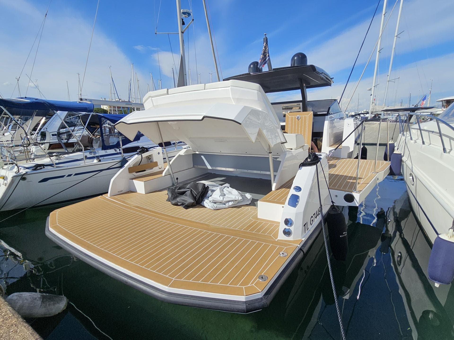 2024 Rio Yachts Daytona 50 docked, showcasing spacious deck and sleek design.