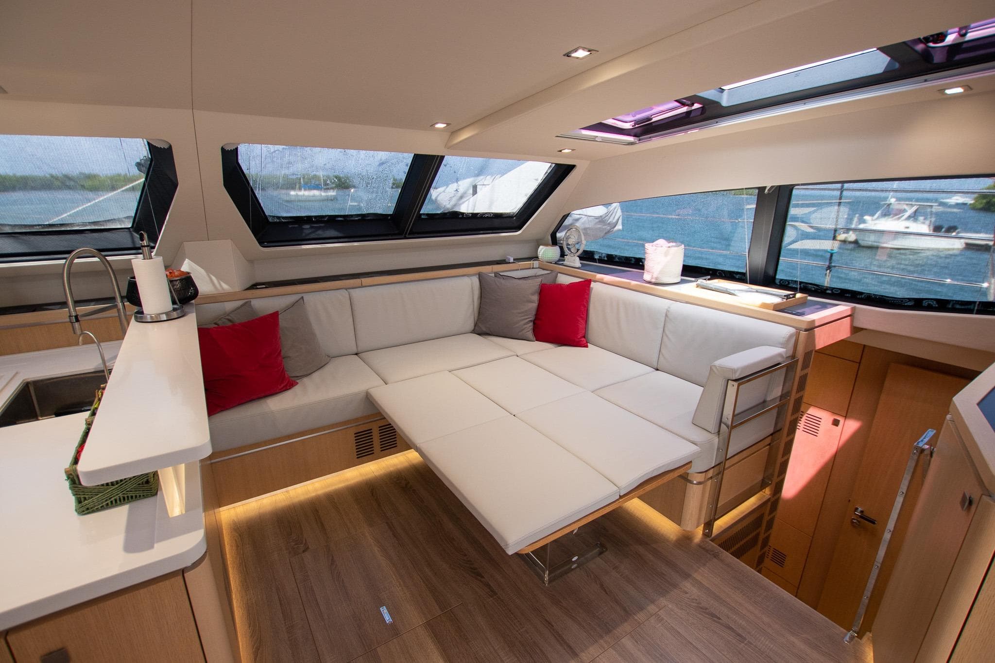 Luxurious interior of 2022 Privilege 510 yacht with modern seating and panoramic windows.