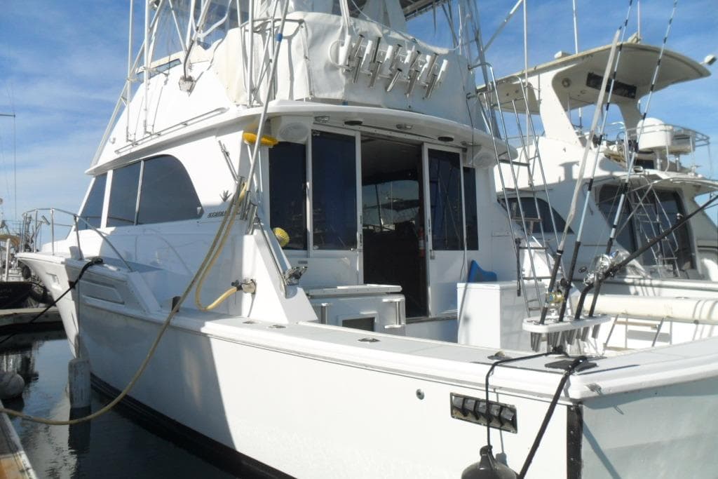 1979 Bertram 46.6 Sport Fisher yacht docked, featuring fishing rods and spacious deck.
