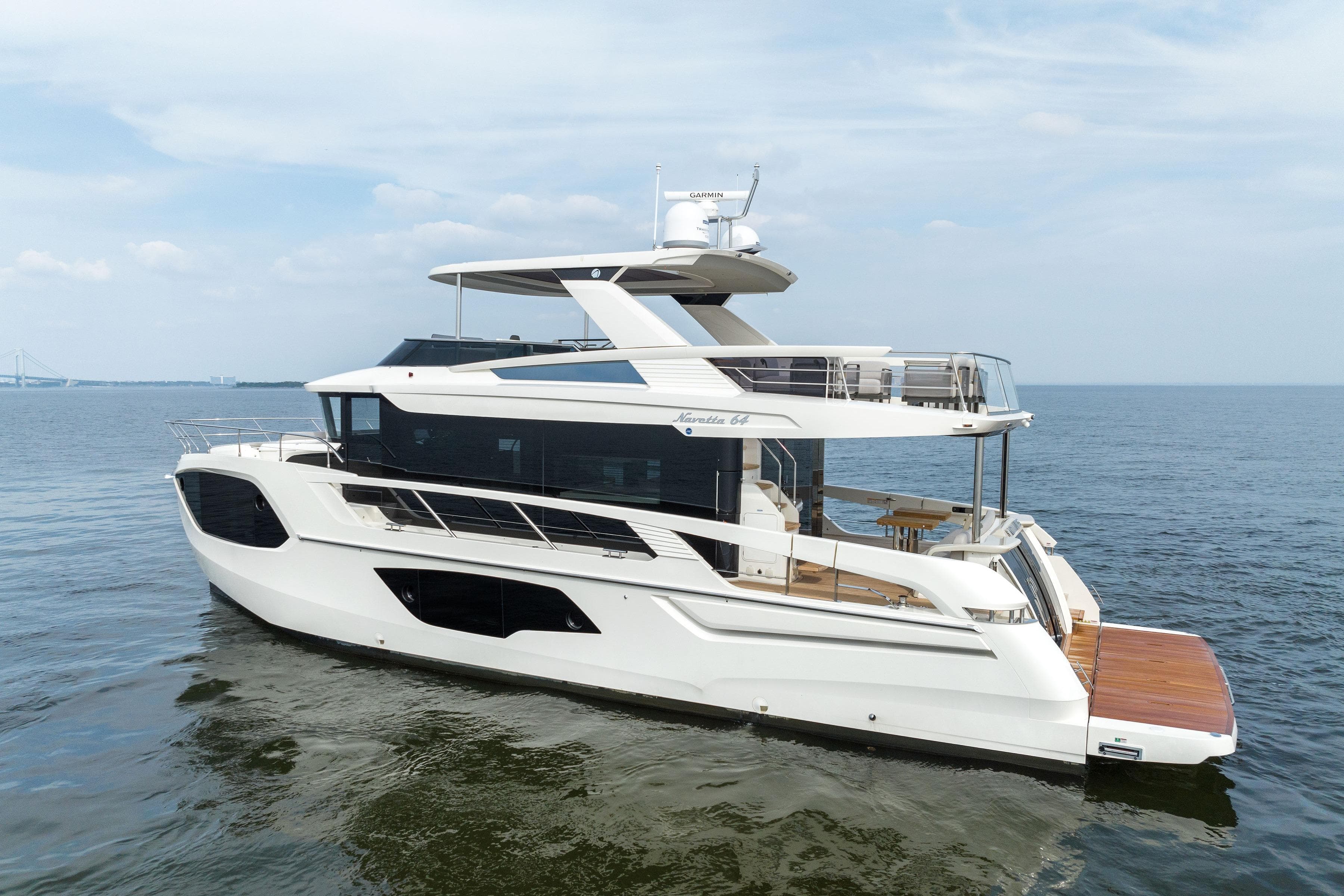 2024 Absolute Navetta 64 yacht cruising on open water, showcasing sleek design and luxury features.