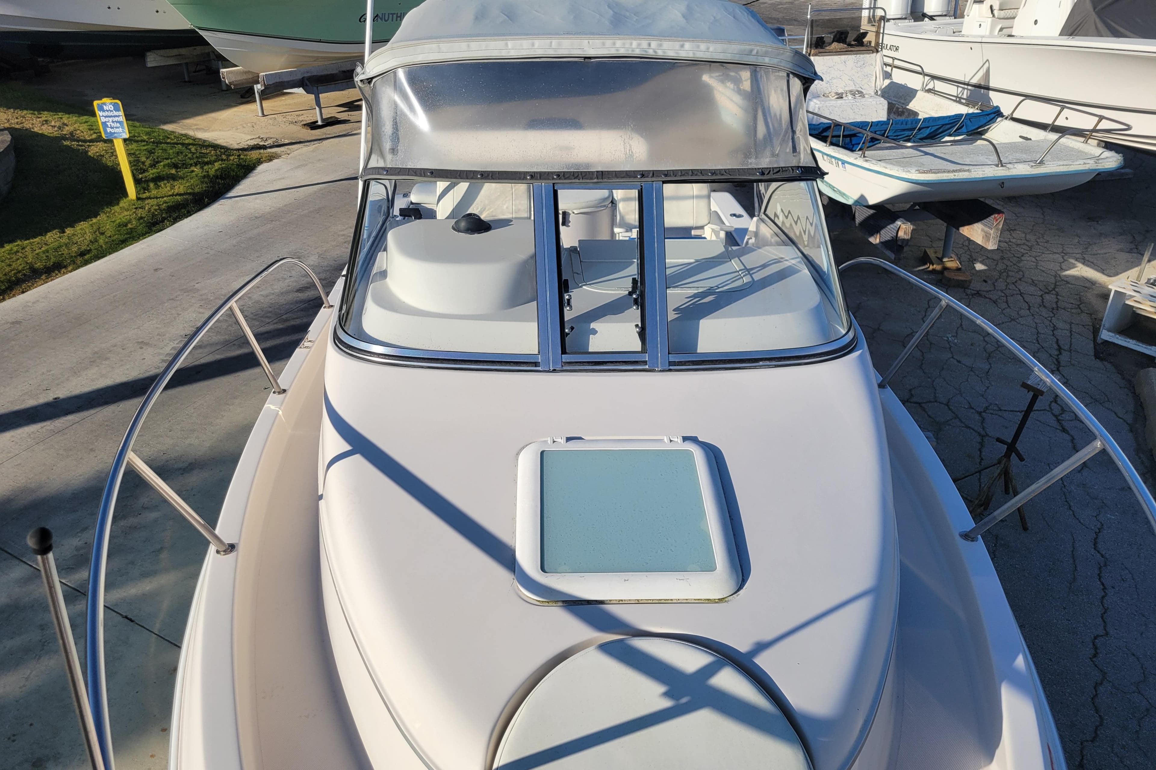 2008 Cobia 236 Walk Around boat with windshield and deck view.