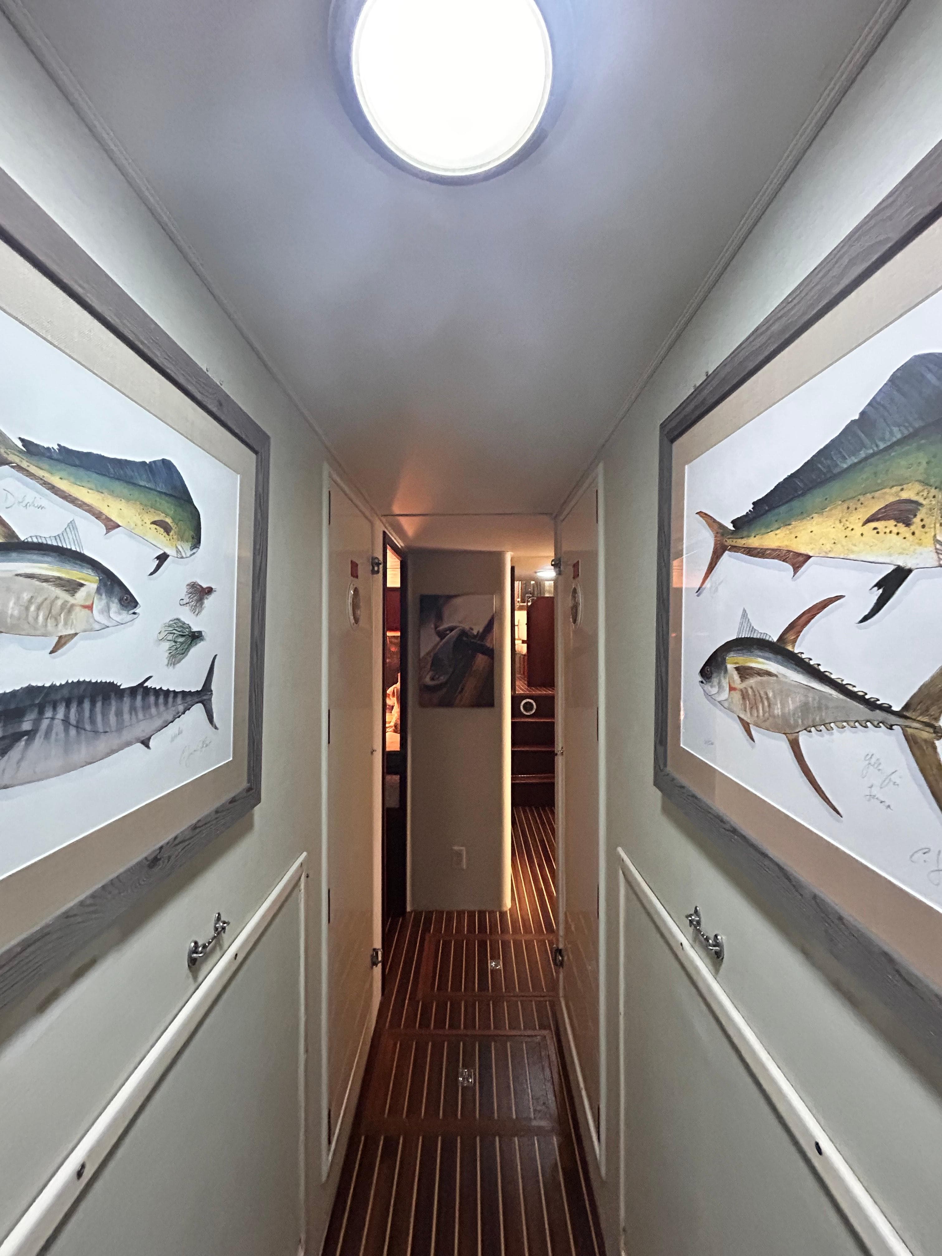 Hallway of 1989 Hatteras 67 Cockpit Motor Yacht with fish artwork.