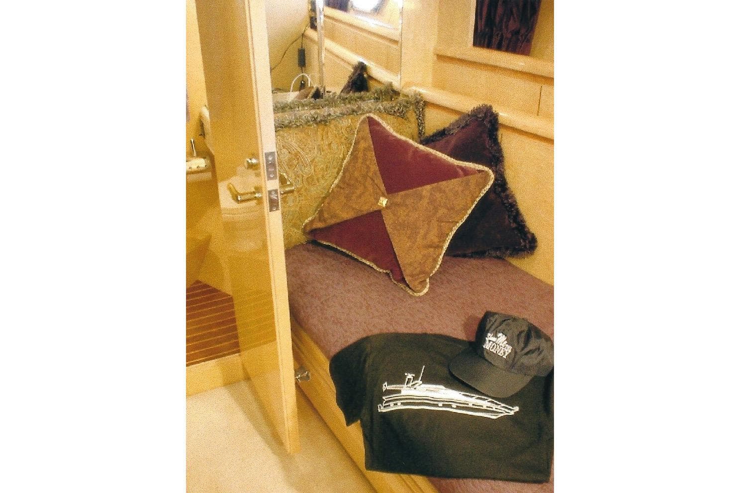 Luxurious Dyna Laguna yacht cabin with plush pillows and branded apparel.