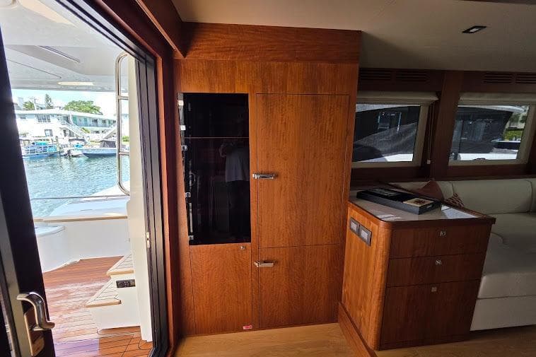 Interior of 2024 Sirena 58 Flybridge MY yacht with wooden cabinetry and water view.