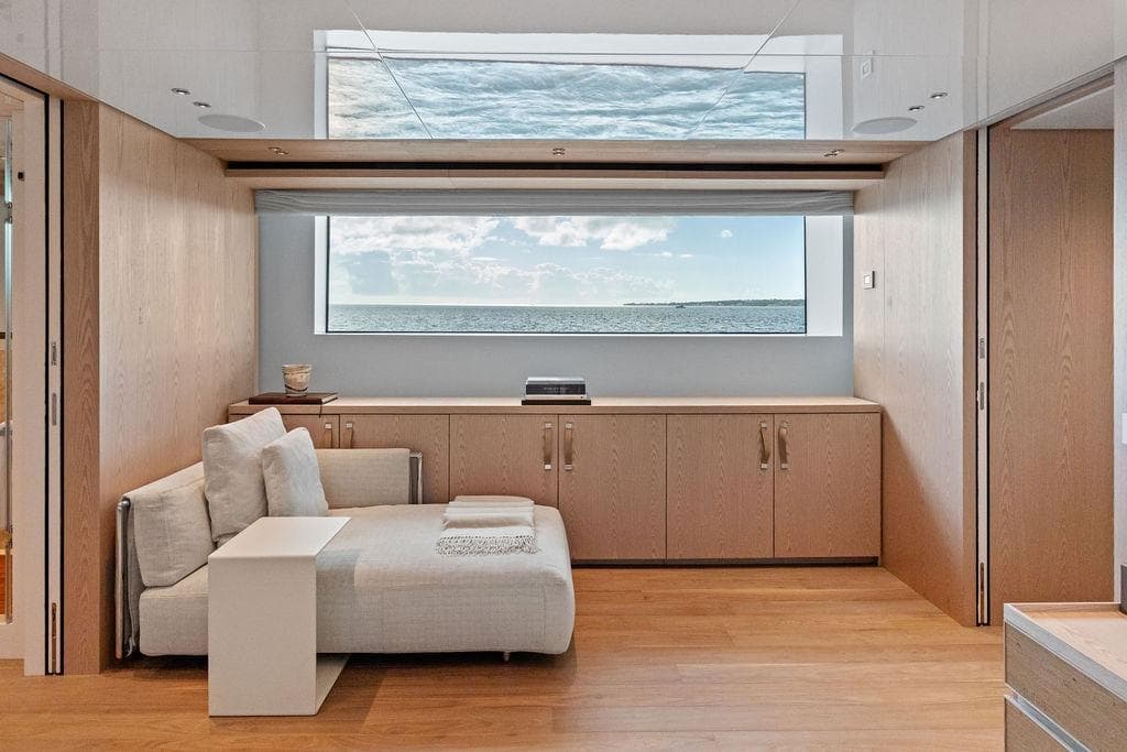 Luxurious interior of 2023 Sanlorenzo SD118 yacht with ocean view window.