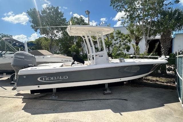 2020 Robalo 246 Cayman boat with Yamaha engine, parked outdoors under a clear sky.