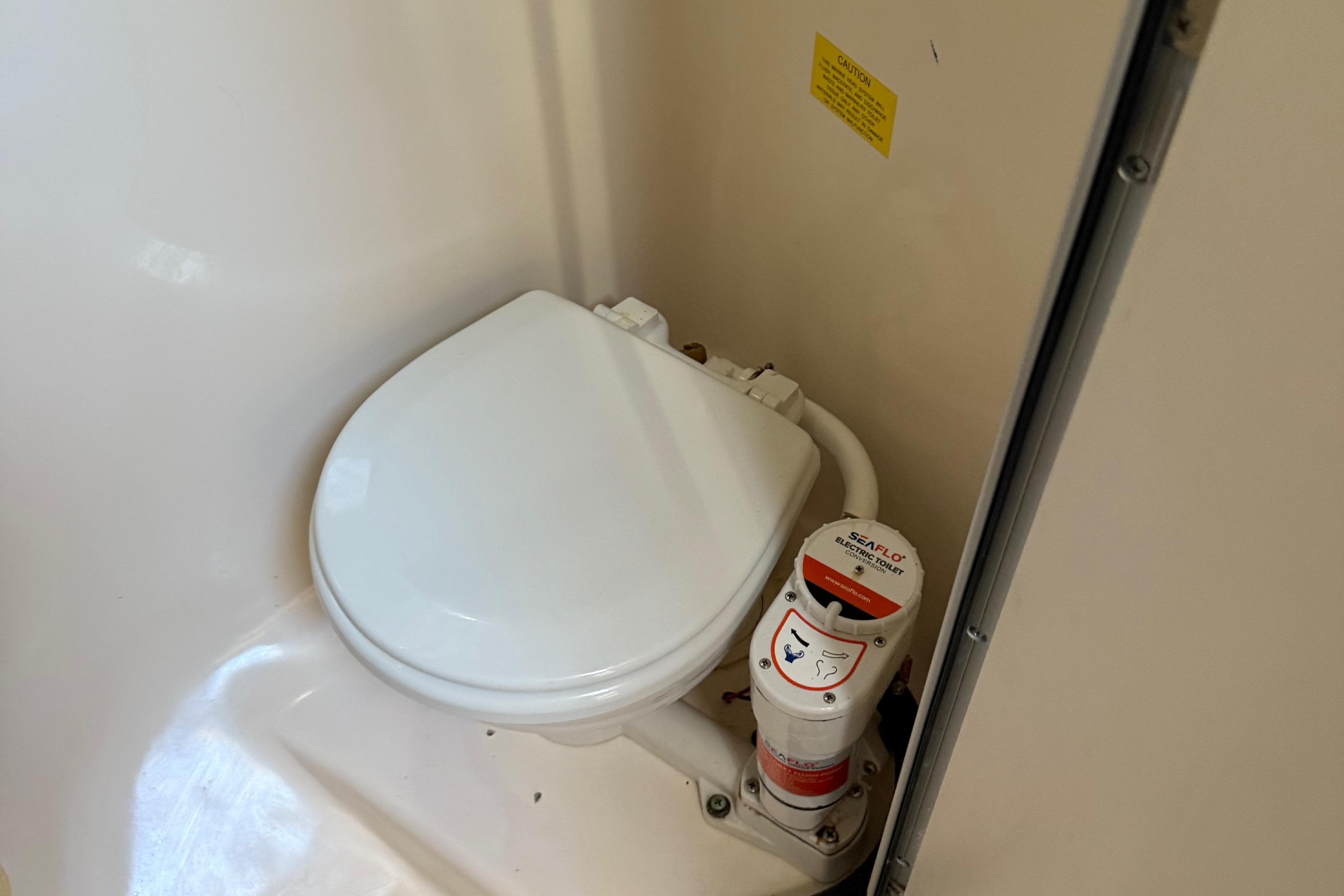 Boat toilet in 1996 Grady-White Marlin 300, featuring Seaflo electric system.