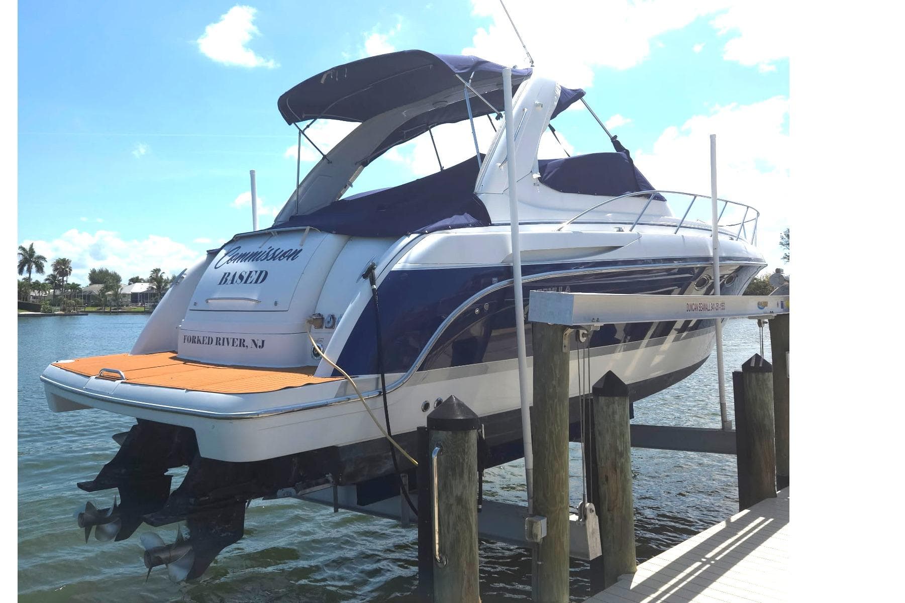 2005 Formula 37 Performance Cruiser docked, featuring sleek design and blue accents.