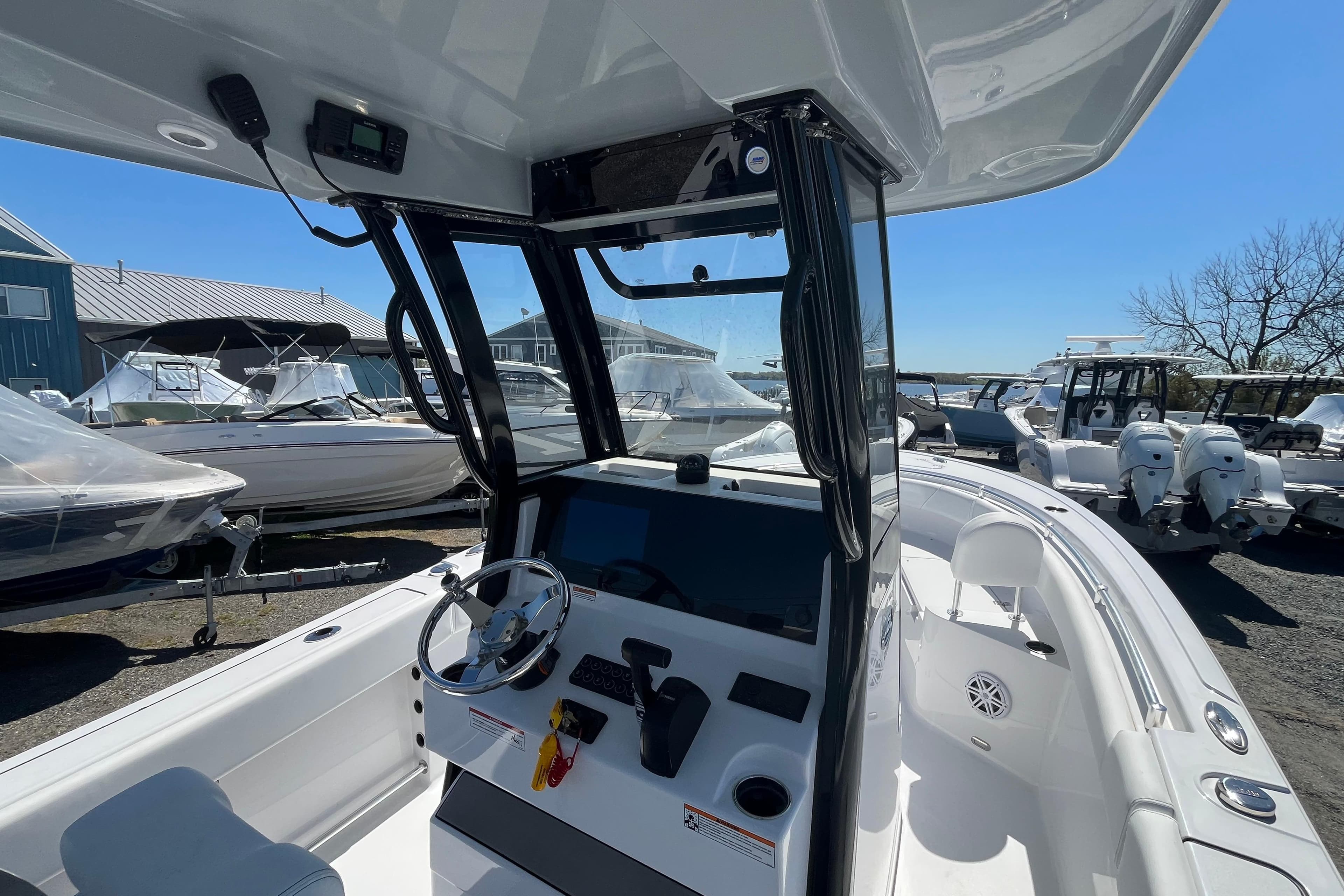 2026 Sportsman Heritage 231 Center Console boat interior with steering wheel and controls.