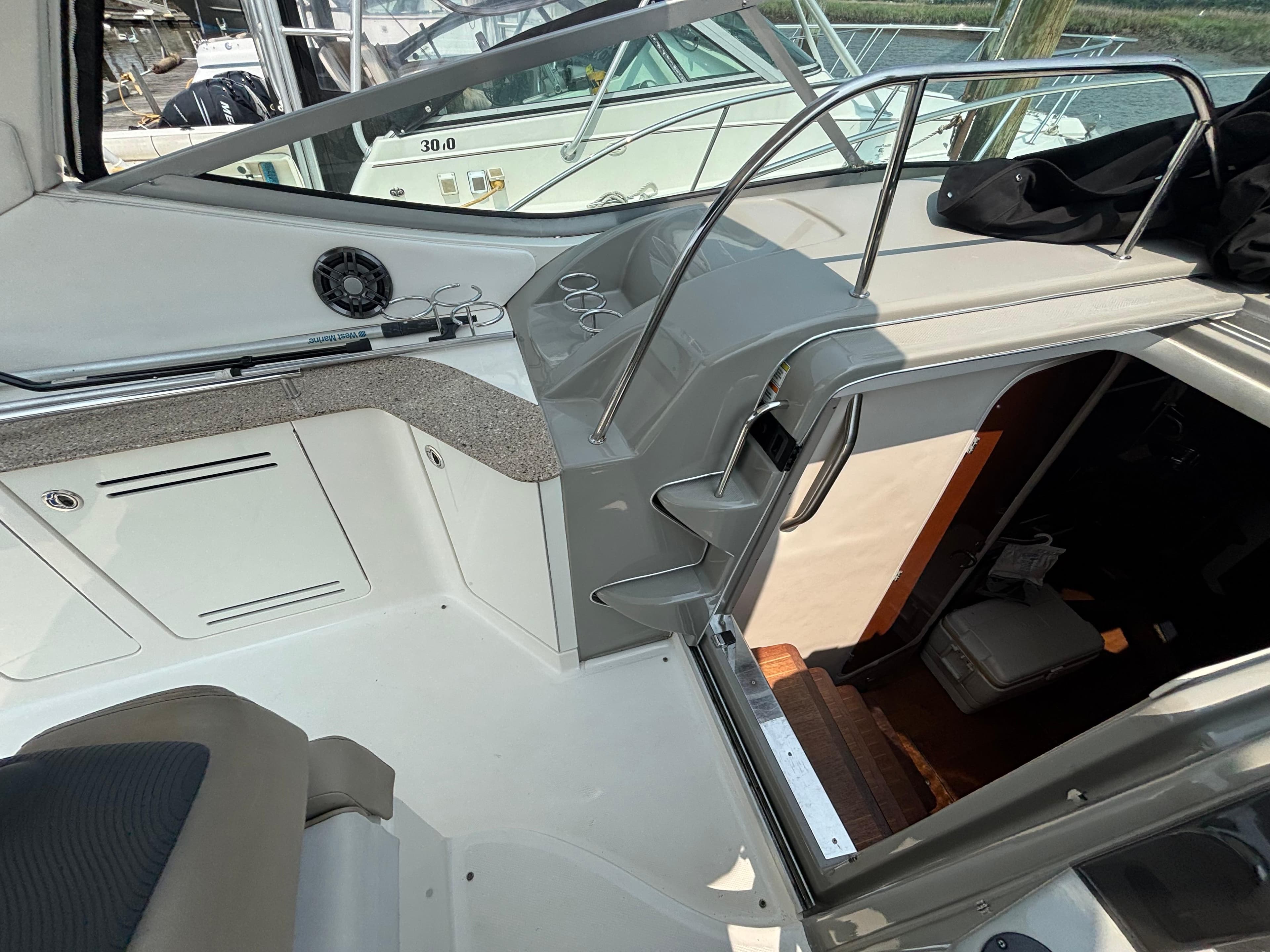 2014 Sea Ray 330 Sundancer cockpit with stairs leading to cabin interior.