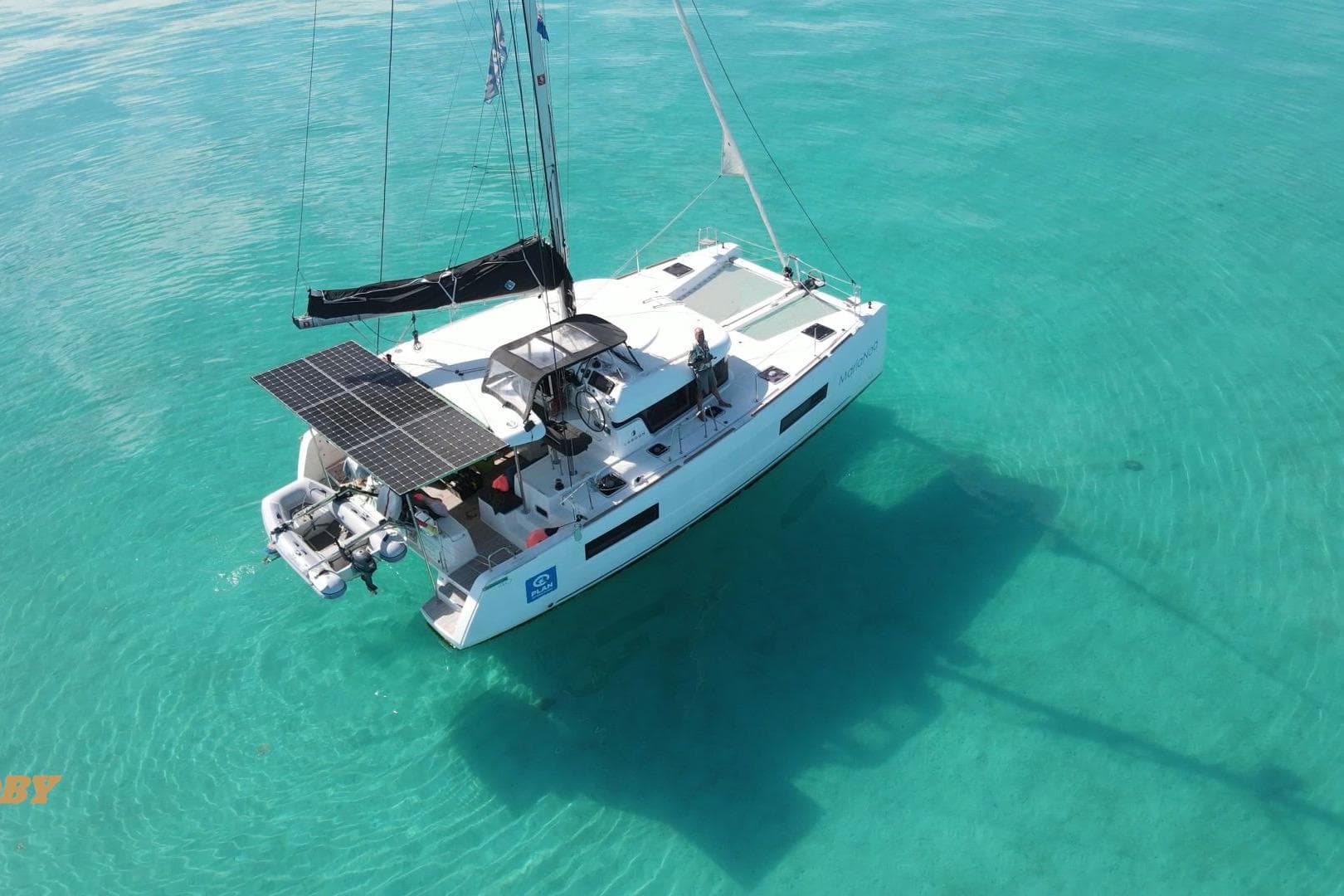 2021 Lagoon 40 catamaran with solar panels on turquoise water.
