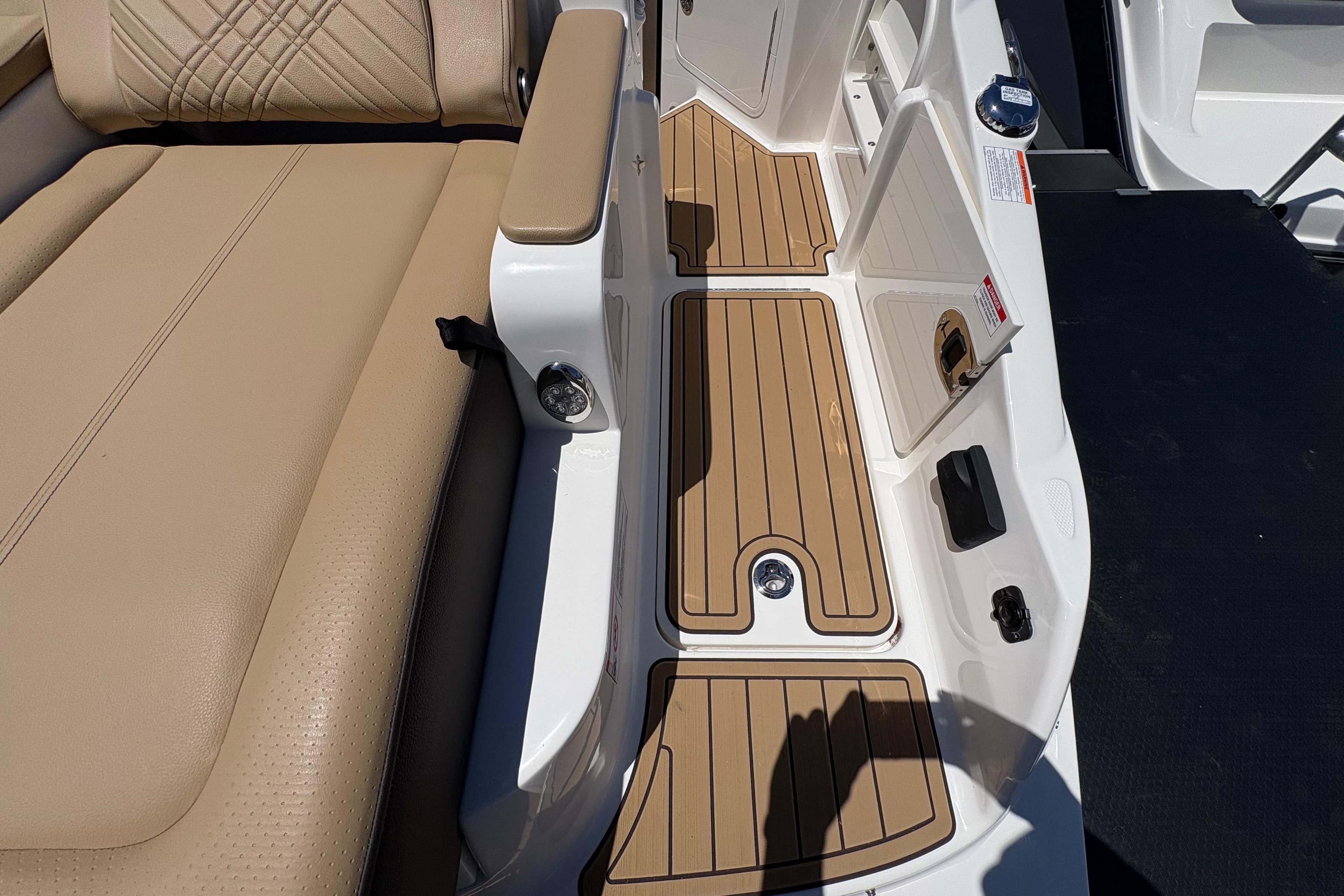 2026 Sea Ray SDX 290 Outboard boat interior with tan seating and teak-style flooring.