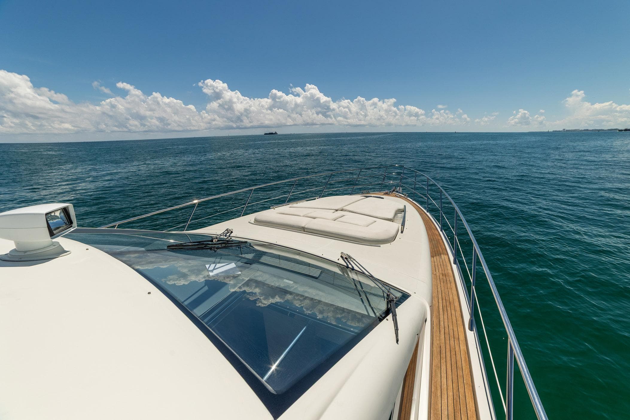 Luxurious 2011 Azimut 68S yacht cruising on open sea under clear skies.