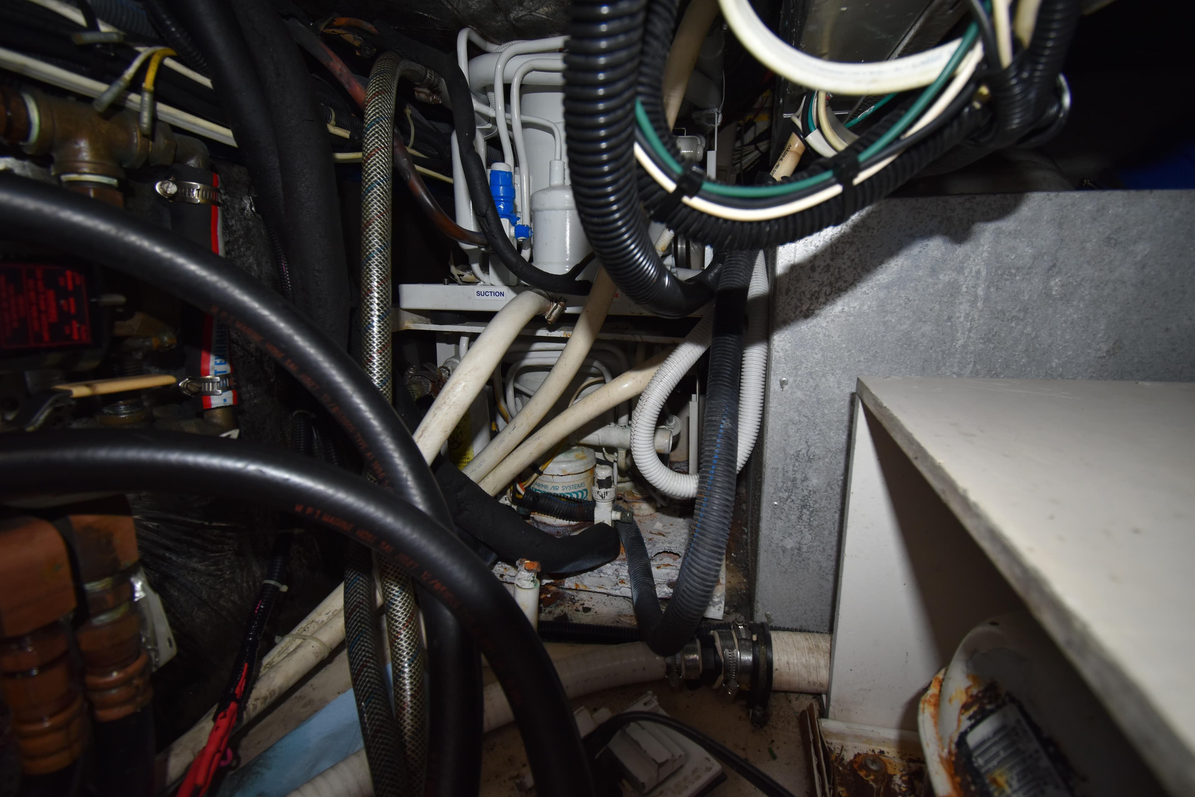 Engine compartment of a 1997 Tiara 4300, showcasing complex wiring and hoses.