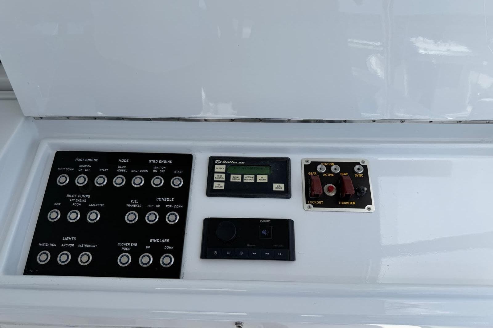 Control panel of a 2003 Hatteras 54 Convertible yacht with various switches and displays.