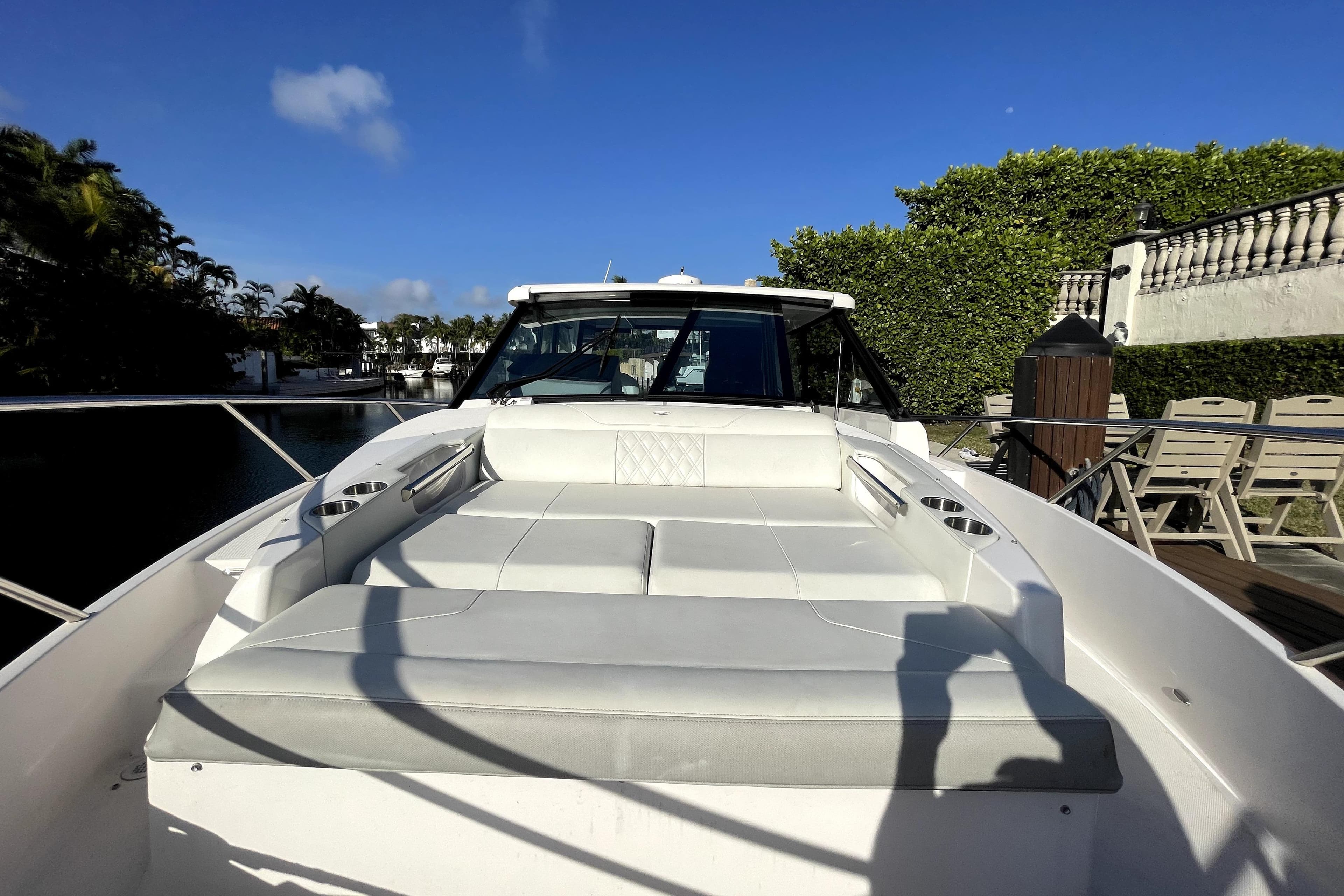 2021 Regal 36 XO boat with spacious deck seating under clear blue sky.