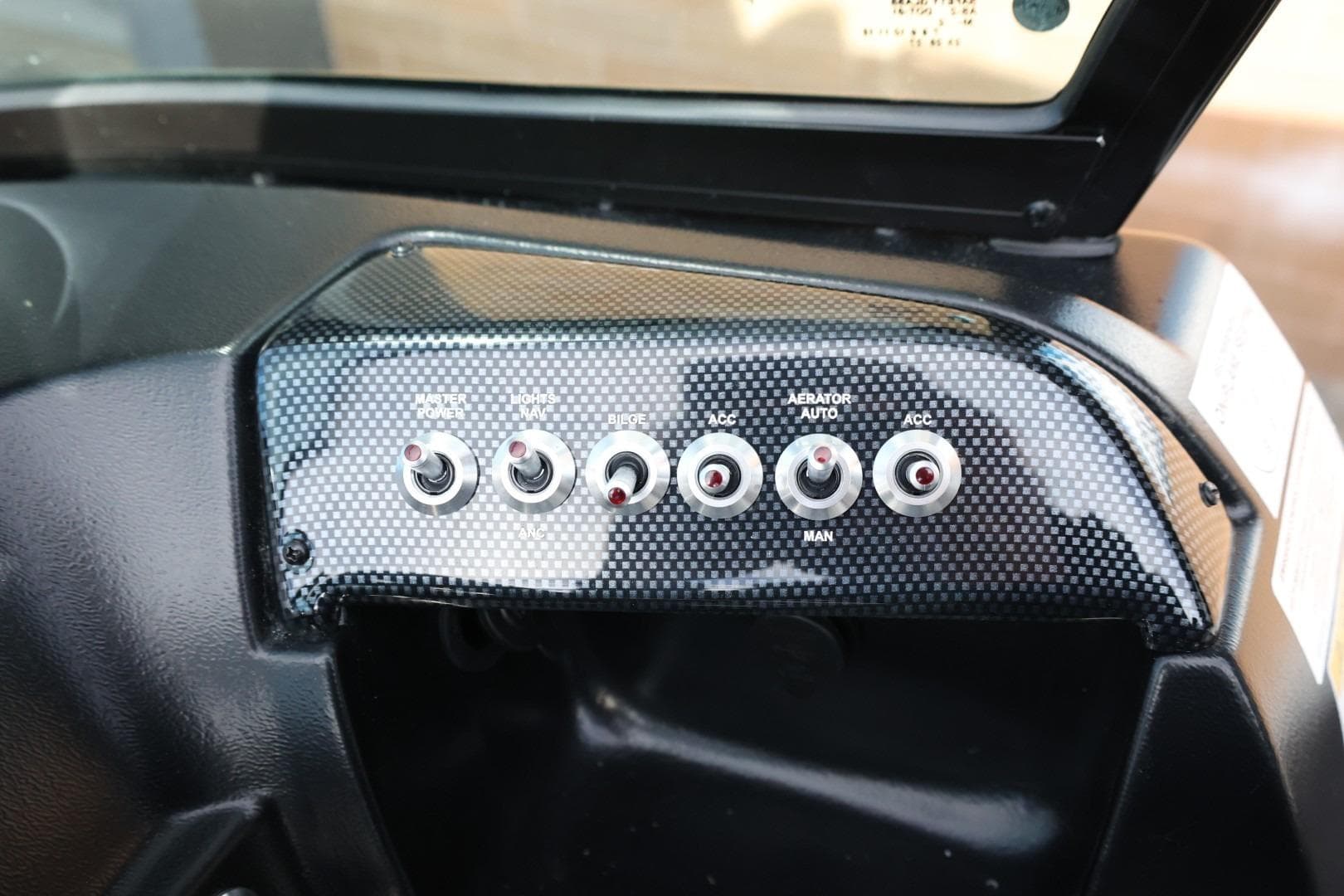 Control panel of 2026 Lowe Fishing Machine 1675 WT with toggle switches.