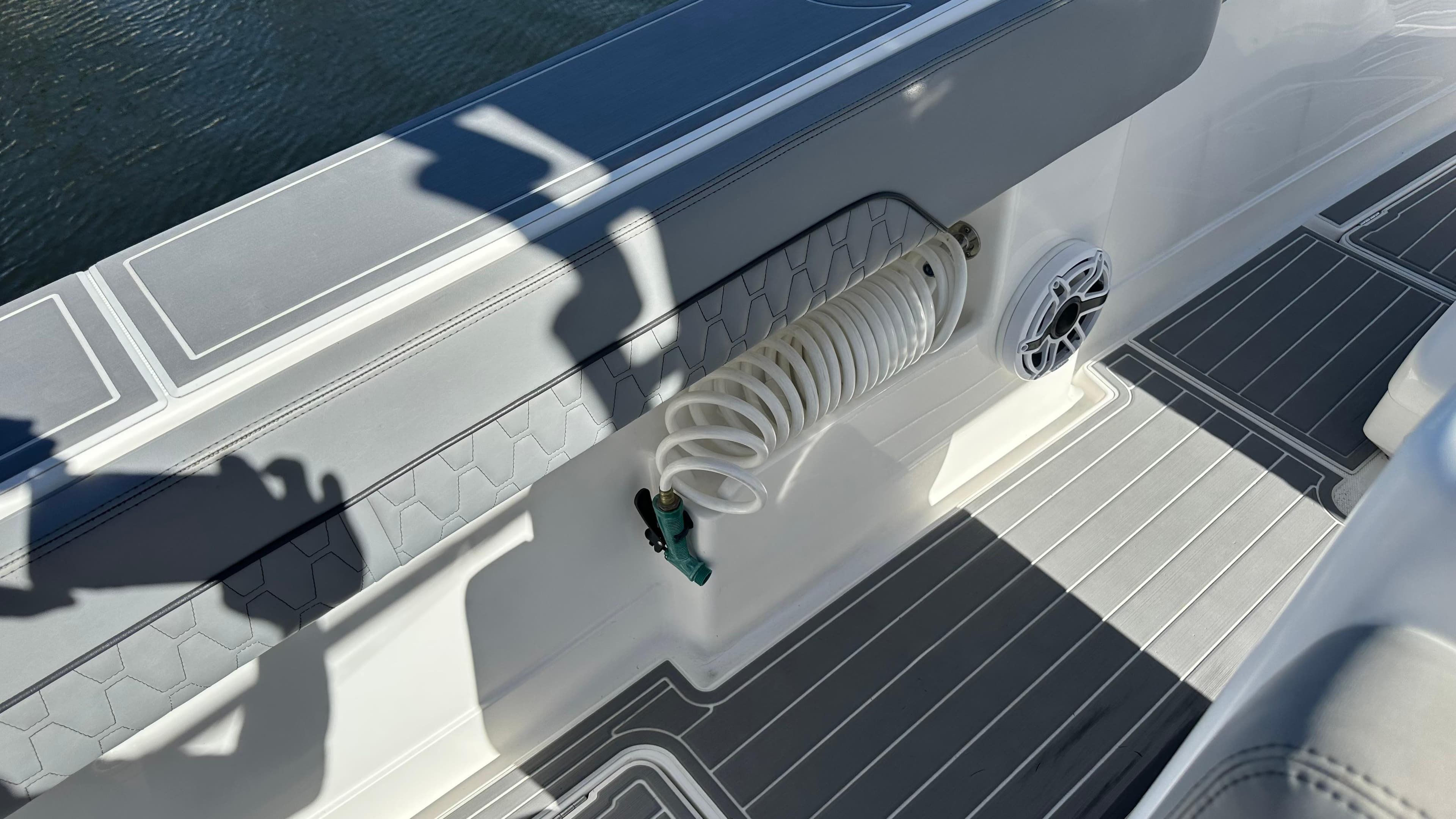 2021 Blackwater 36 SF boat deck with coiled hose and speaker.