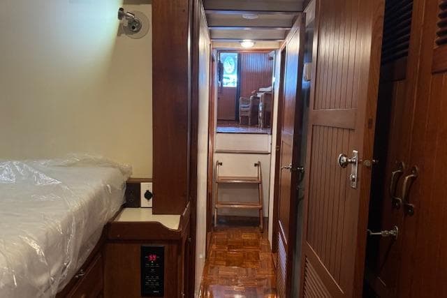 1986 Krogen 42 Classic yacht interior with wooden paneling and cozy sleeping area.