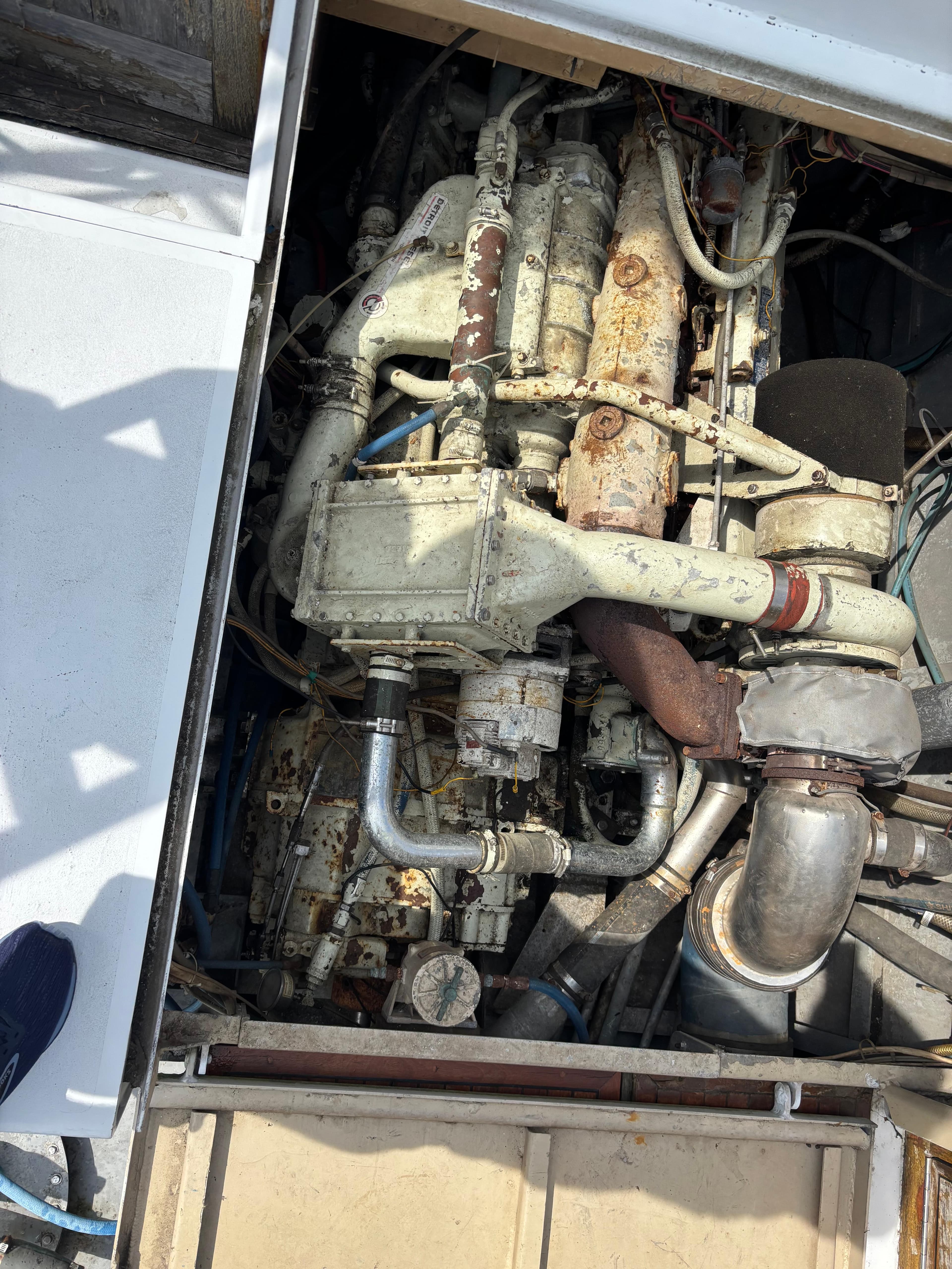 Engine compartment of a 1974 Striker Canyon Runner boat, showing mechanical components and piping.