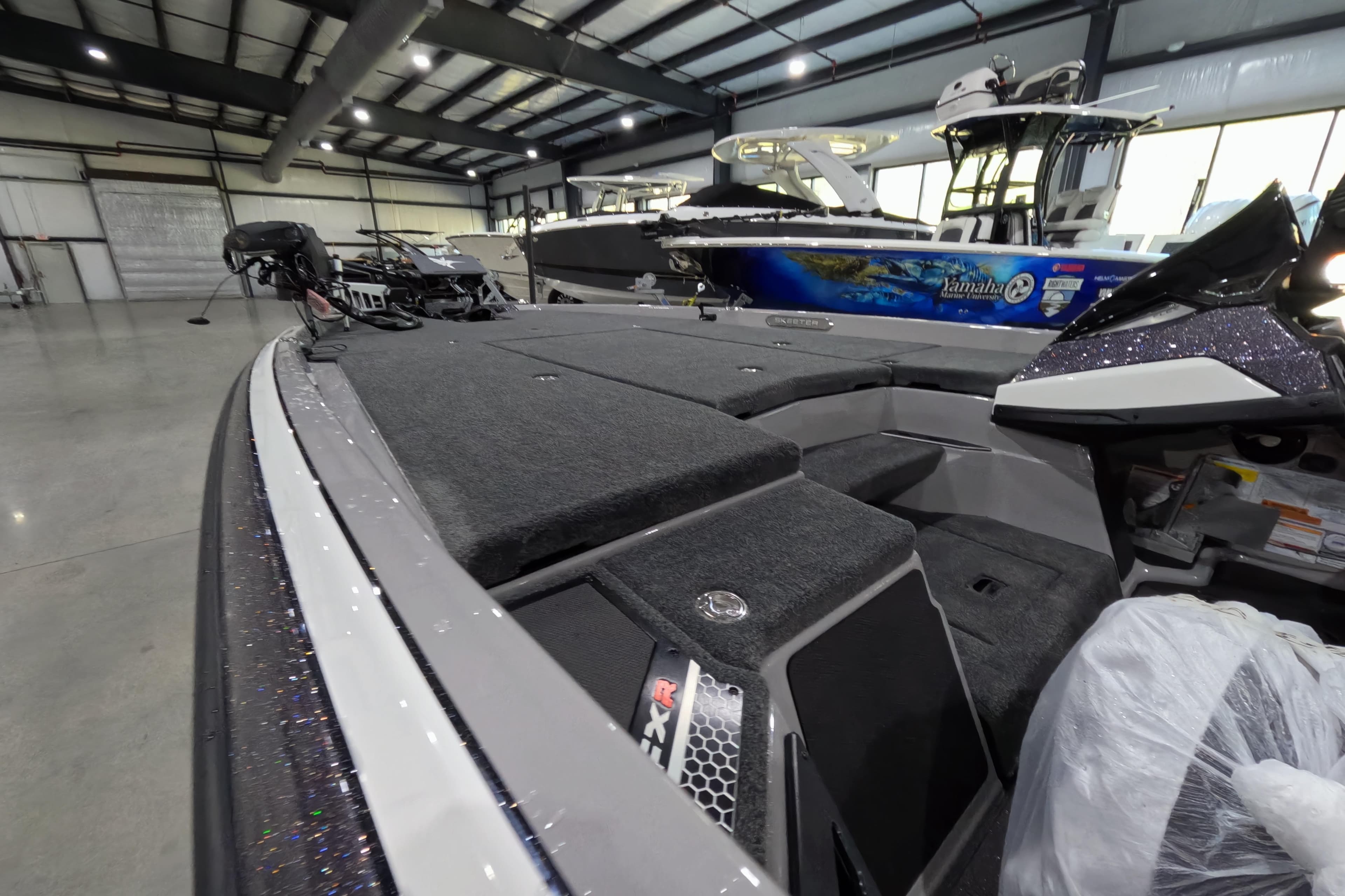 2026 Skeeter boat interior in a showroom, featuring spacious deck and modern design.