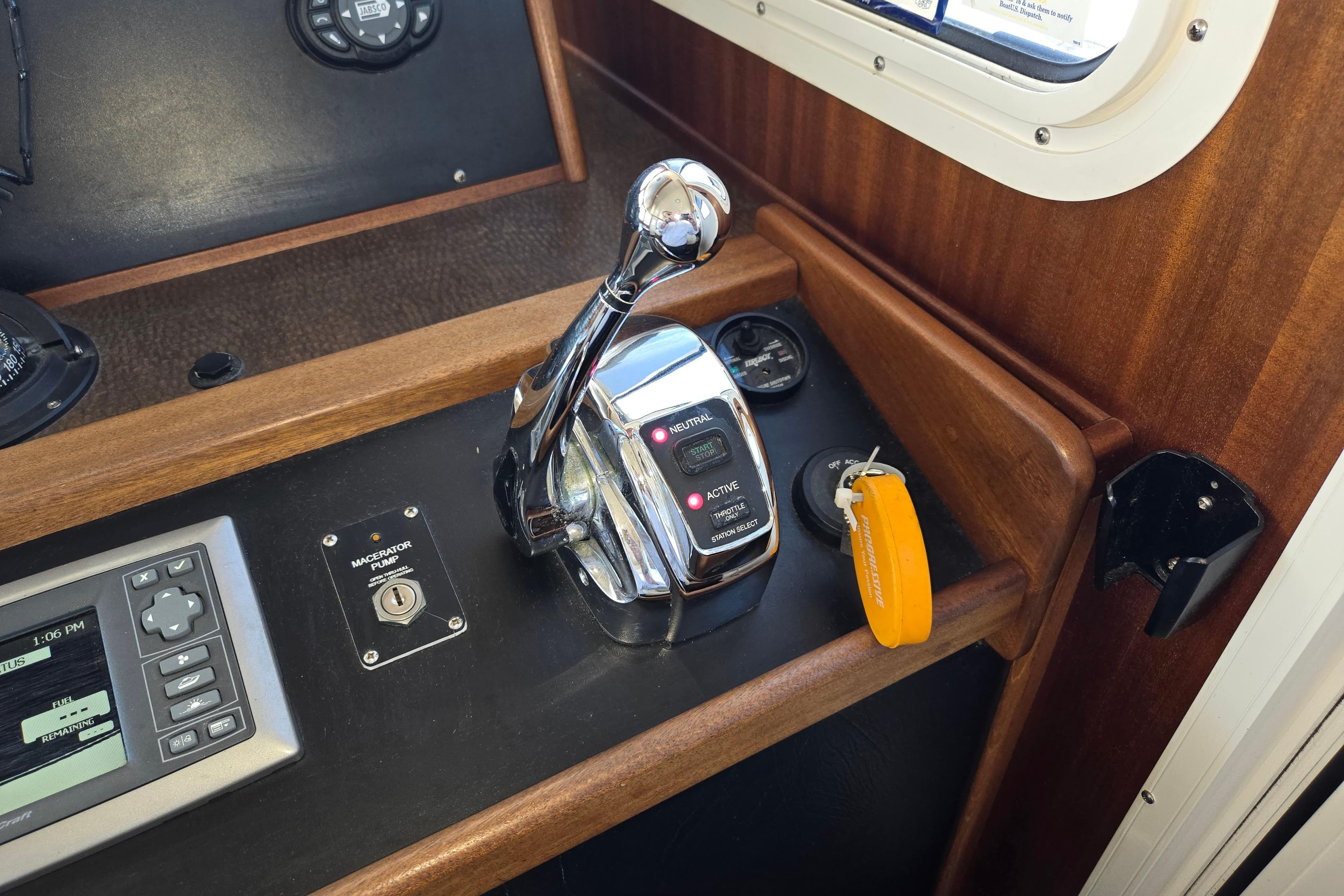 Control panel of a 2012 American Tug 365 Flybridge with throttle and navigation controls.