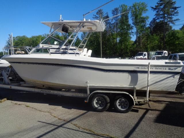1980 Grady-White 241 WEEKENDER boat on trailer, parked outdoors.