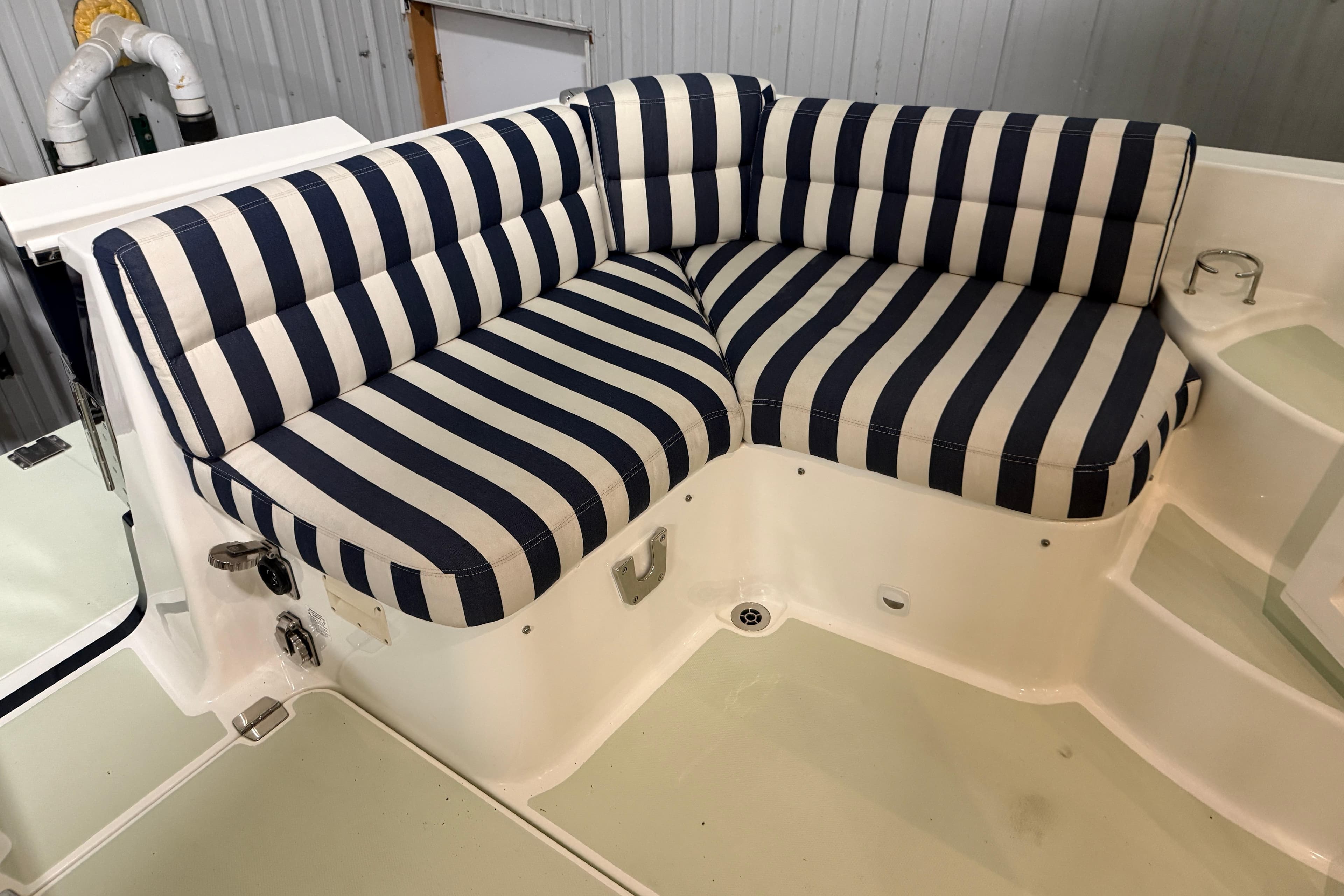 Striped seating on 2017 Back Cove 37 boat, featuring navy and white cushions.