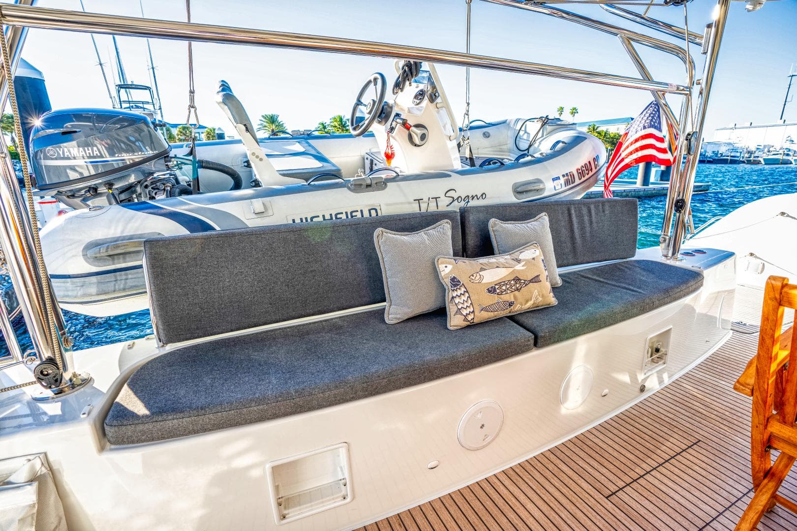 2024 Lagoon 46 yacht with cushioned seating, decorative pillows, and a view of the marina.