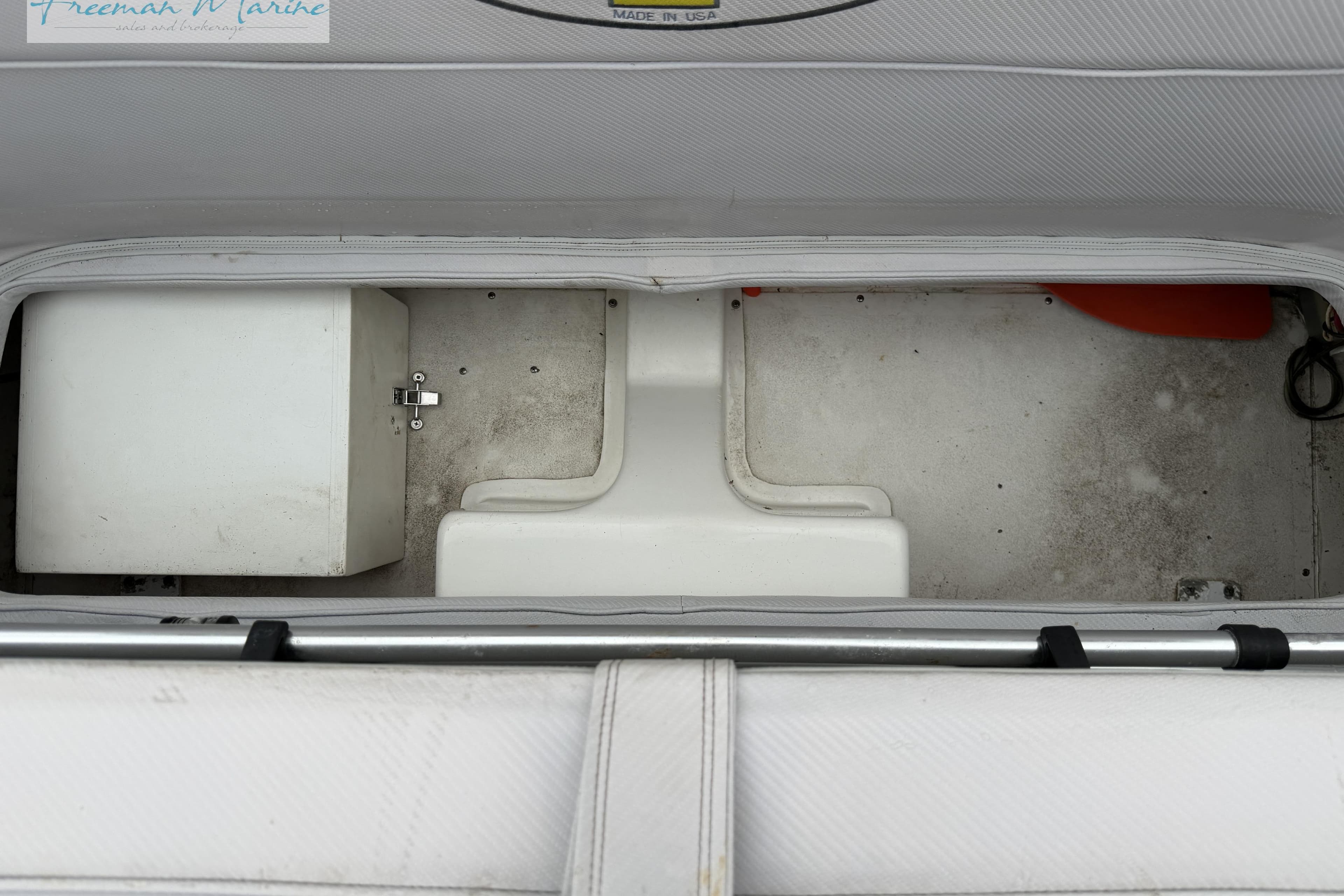 Storage compartment of a 2000 Cigarette 30' Mystique boat, featuring a white interior.