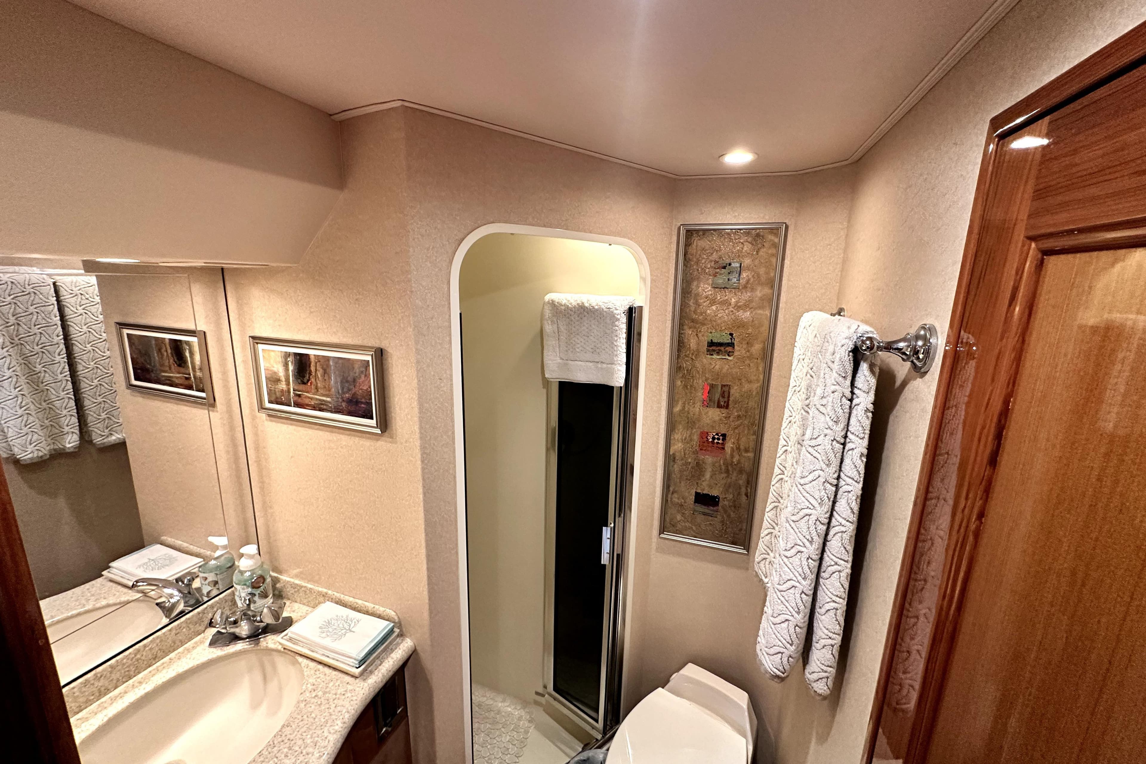Luxurious bathroom interior of 2003 Viking 61 Convertible yacht with elegant fixtures.