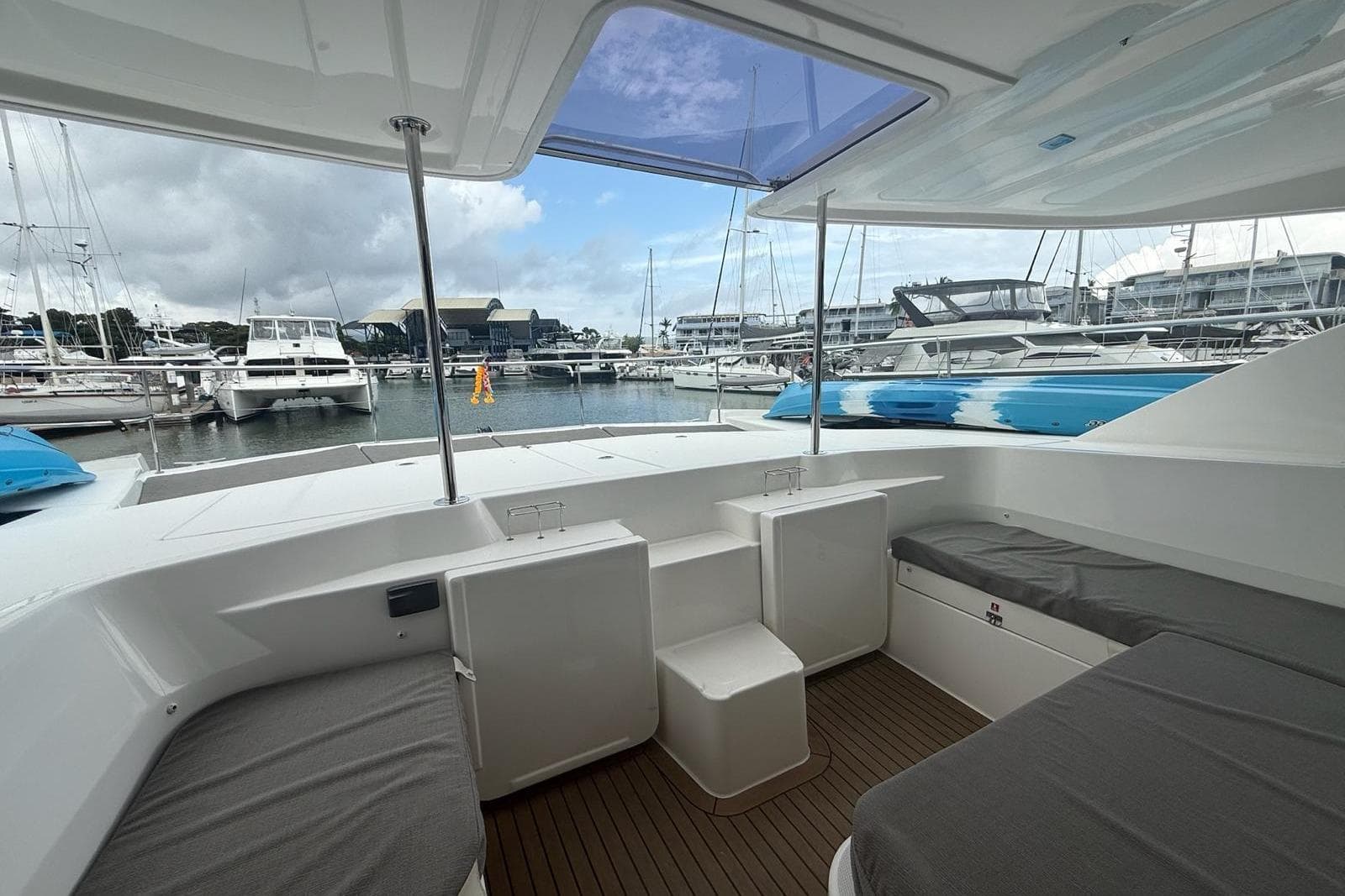 2019 Leopard 51 Powercat interior view at marina, showcasing seating and sleek design.