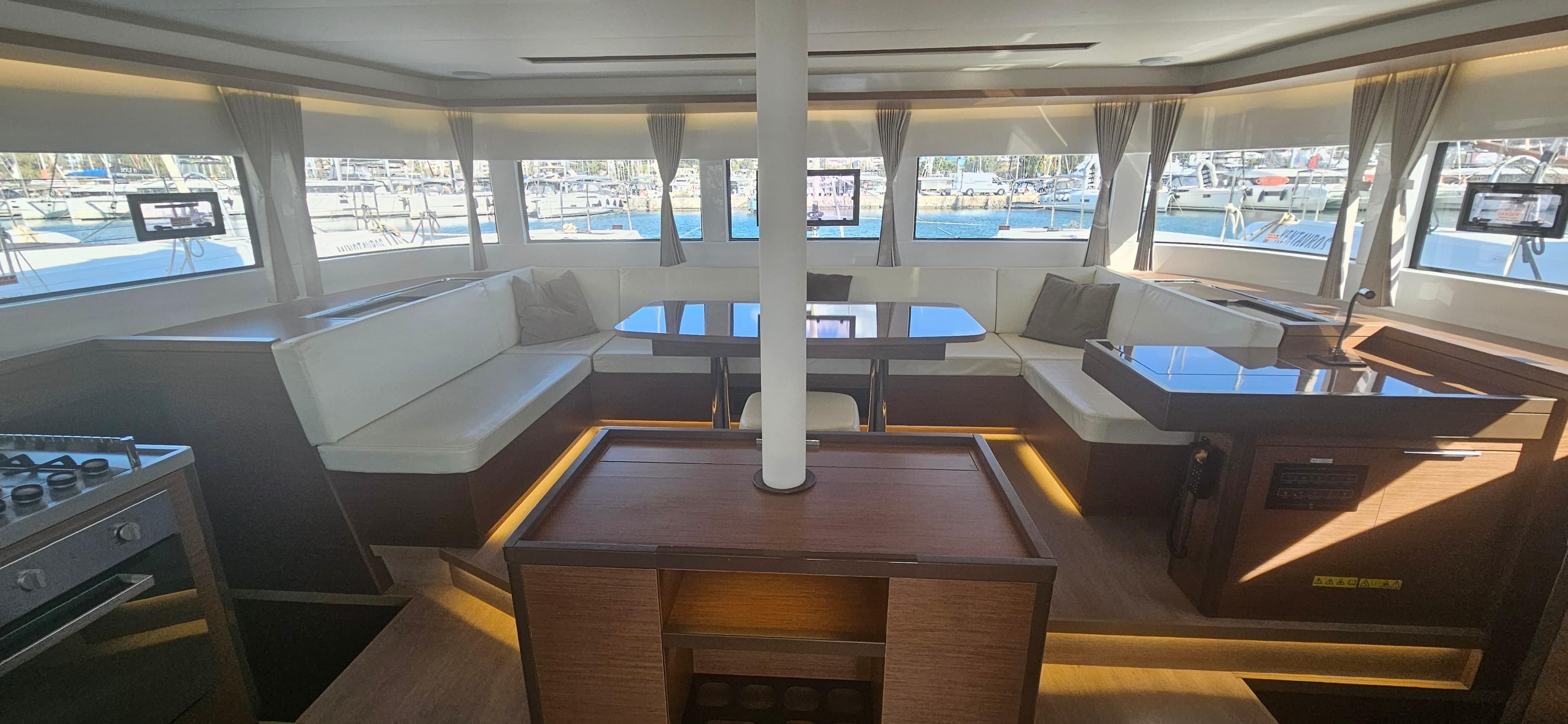 Luxurious interior of 2022 Lagoon 50 catamaran with spacious seating and panoramic windows.