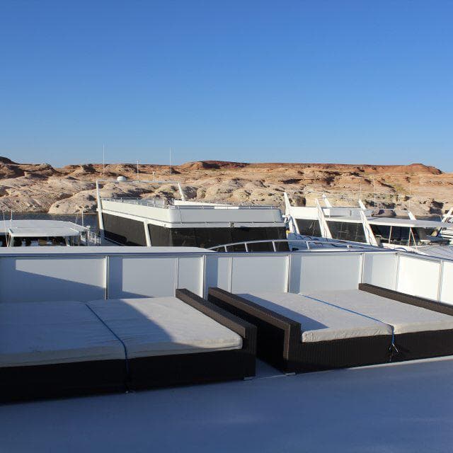 Luxury yachts docked near rocky landscape under clear blue sky, Bravada Apollo Trip #1, 2014.