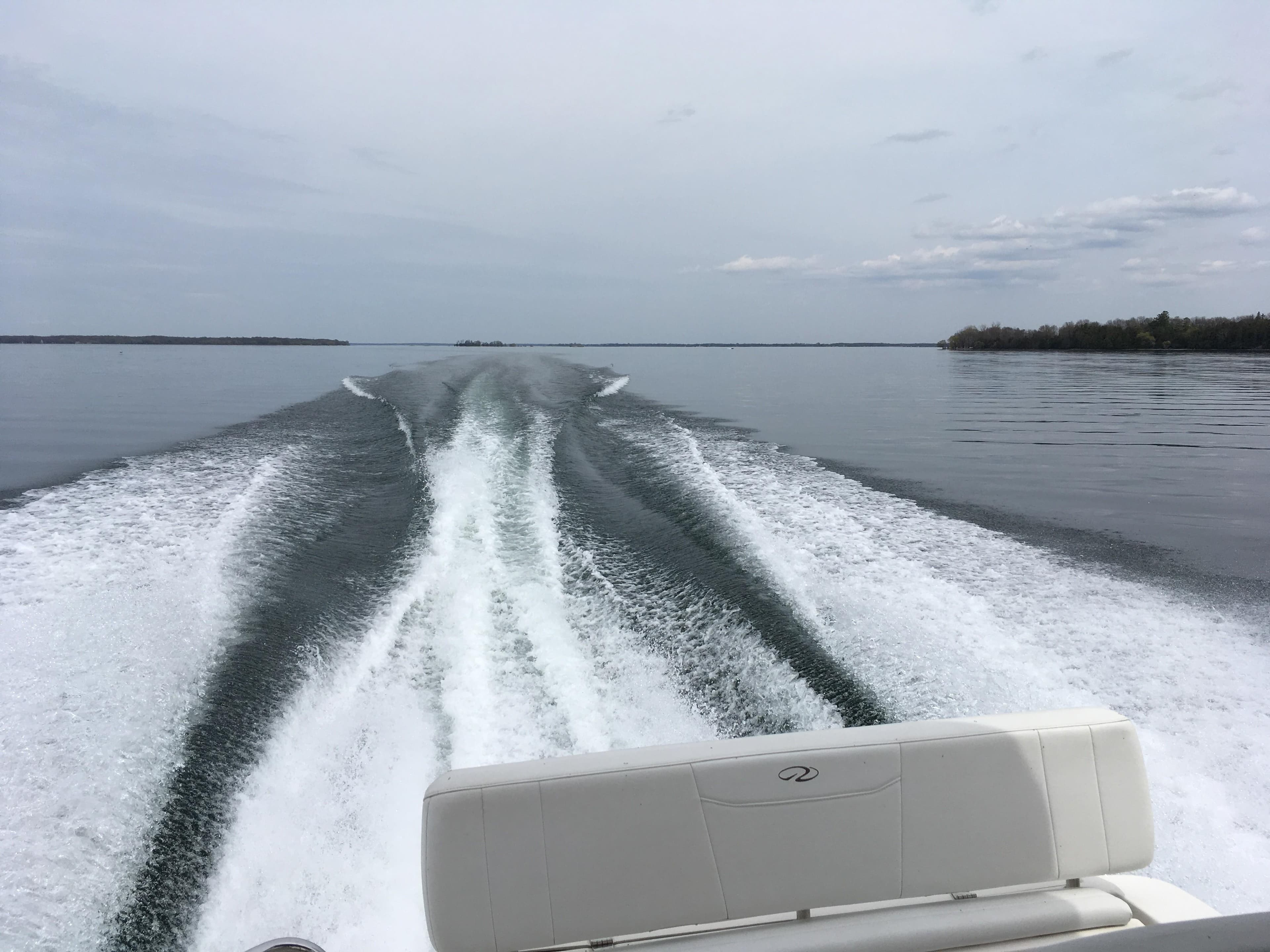 Wake trail behind 2005 Regal 3060 Window Express boat on calm water.