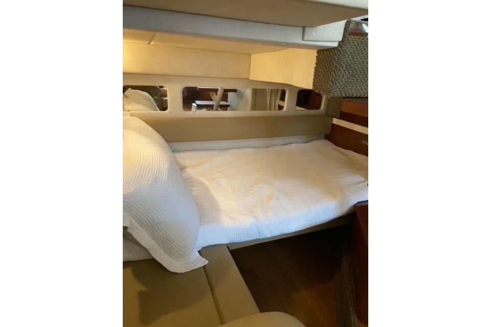 2012 Sea Ray 350 Sundancer cabin with cozy bed and modern interior design.