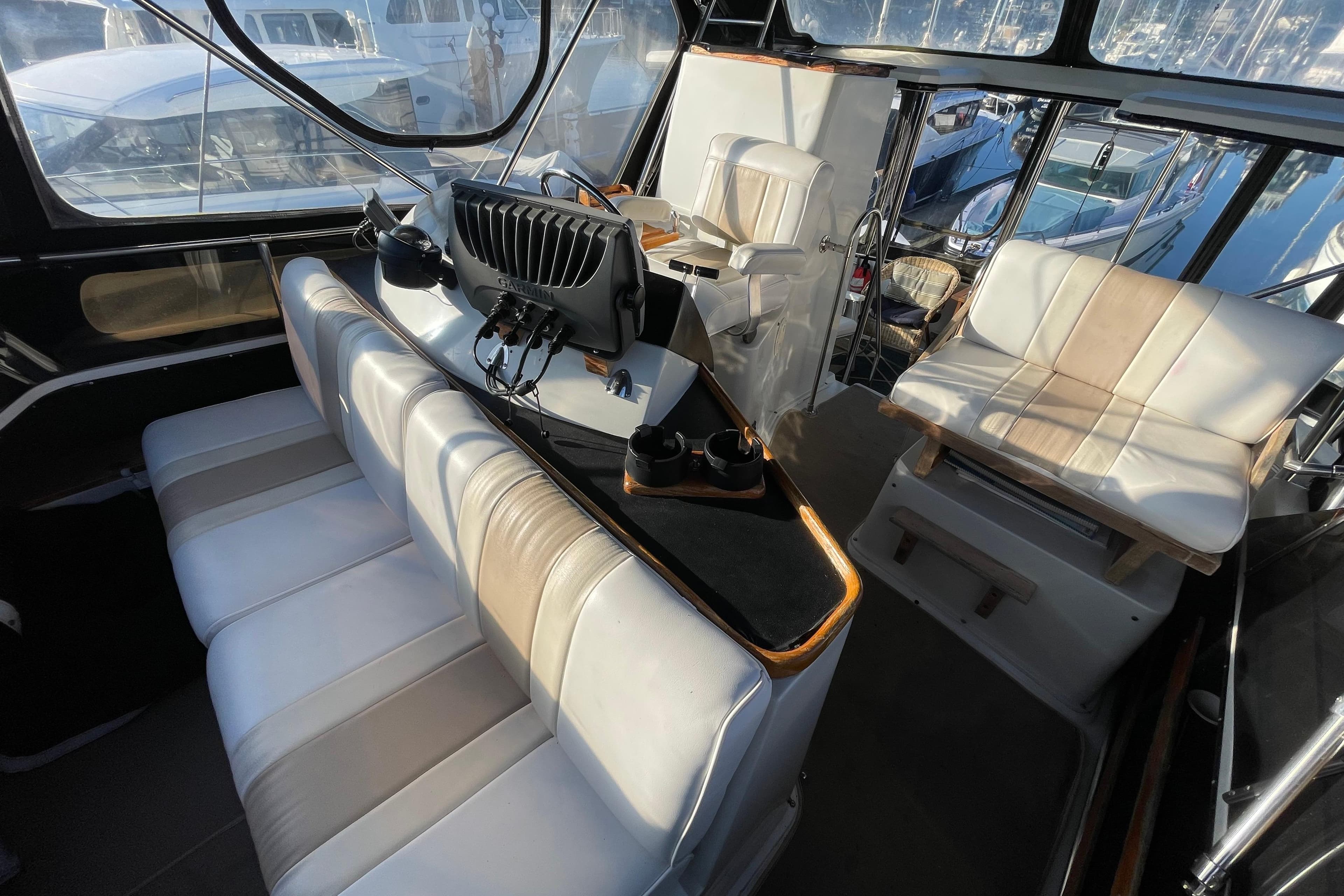 1988 Carver 3607 Aft Cabin Motor Yacht interior with seating and navigation equipment.
