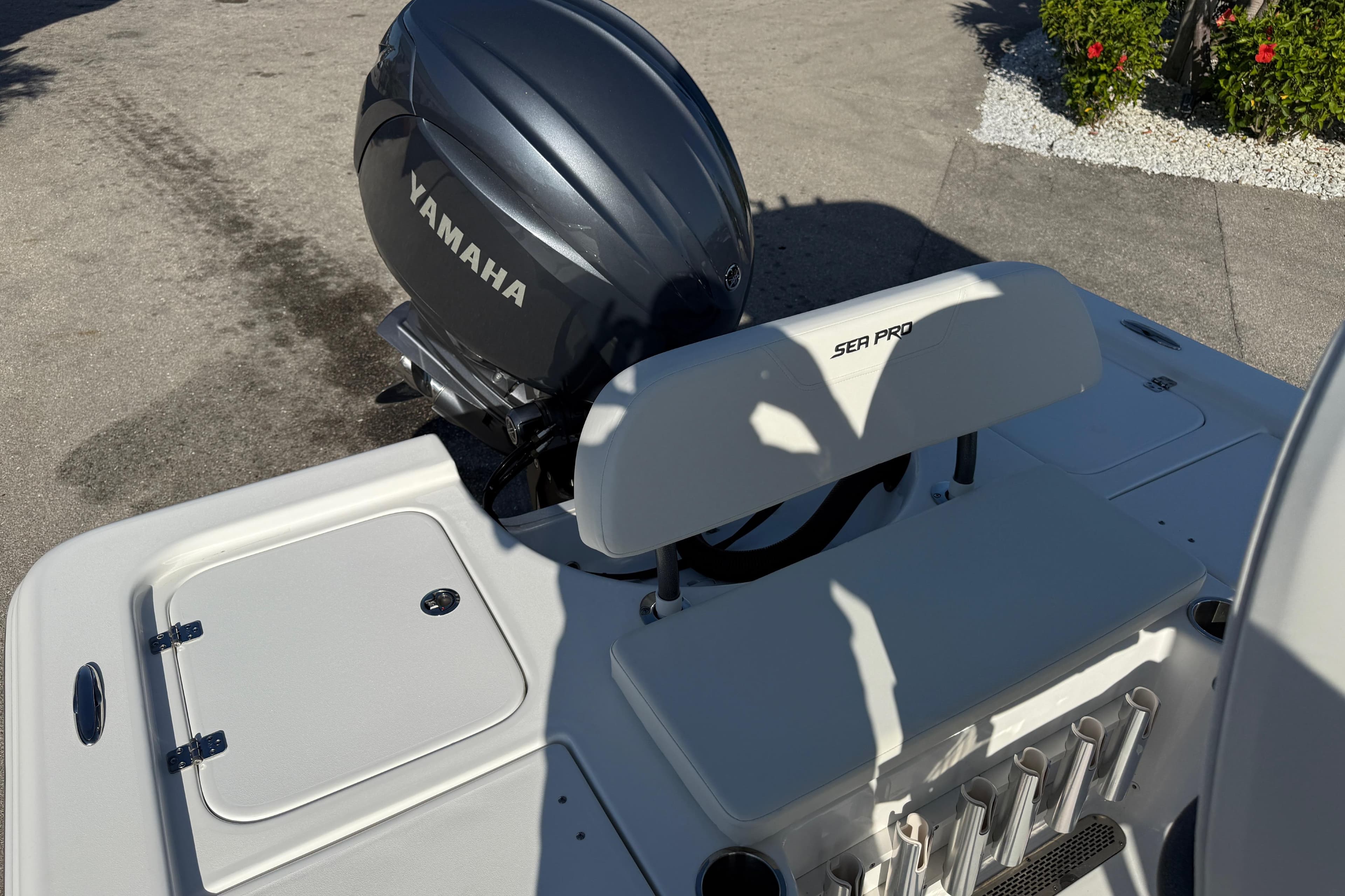 2025 Sea Pro 210 Bay boat with Yamaha engine, featuring sleek design and fishing rod holders.