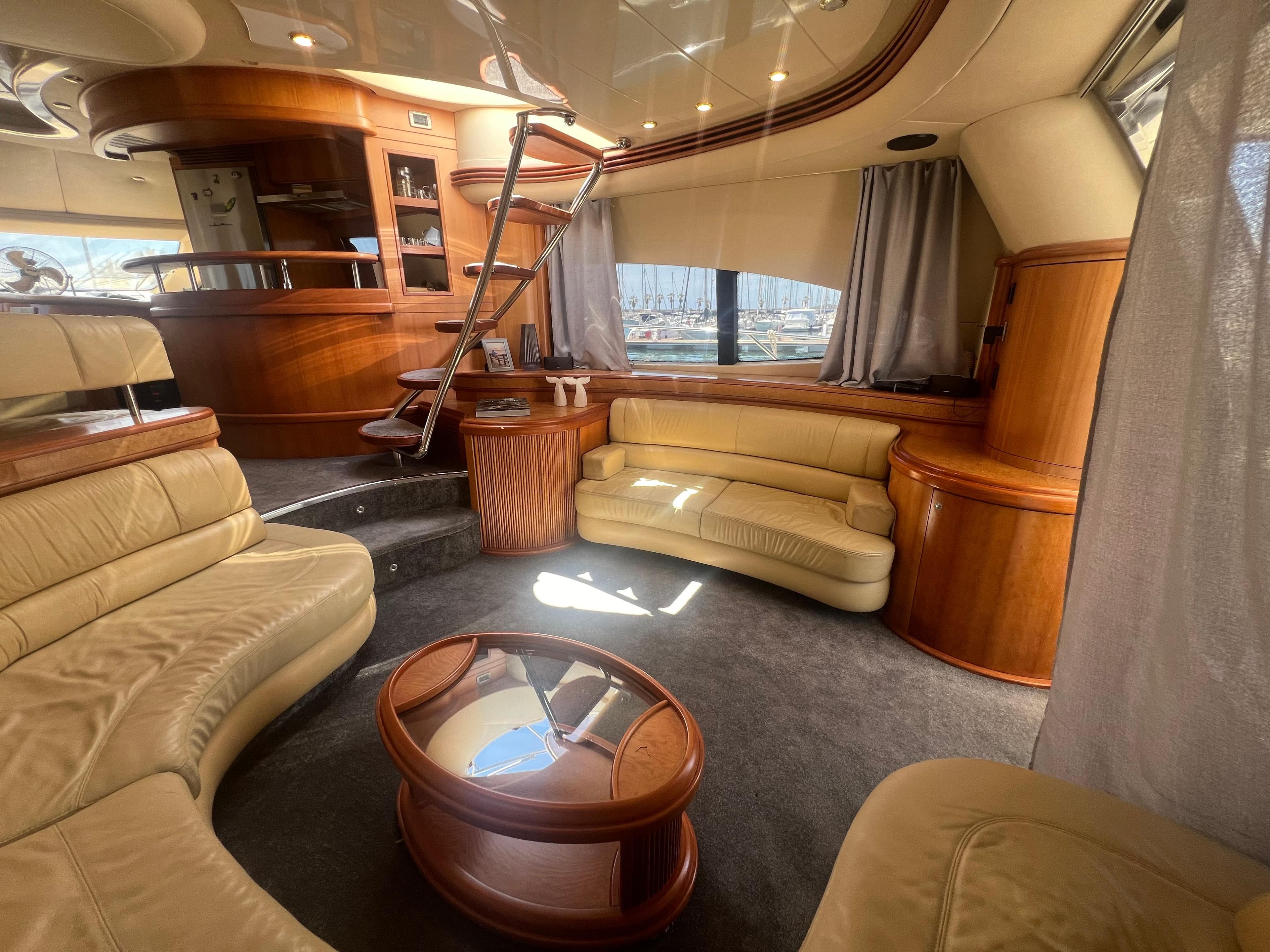 Luxurious interior of a 2007 Azimut 68E yacht with elegant wood and leather furnishings.