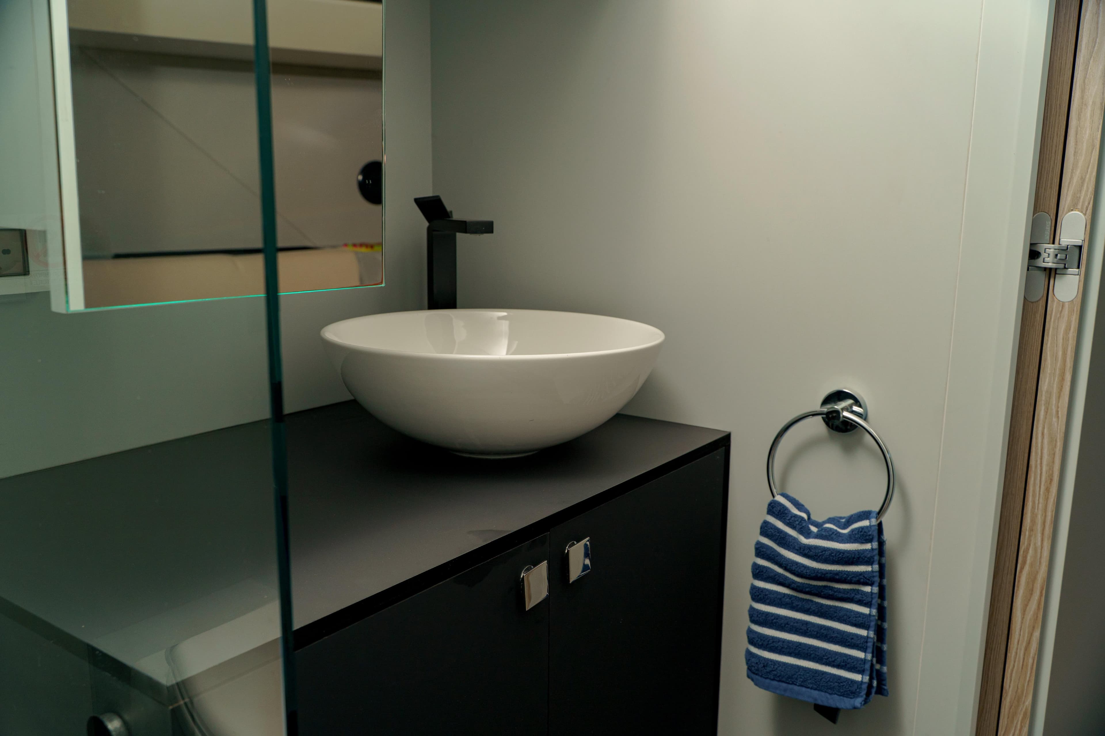 Modern bathroom sink with striped towel in 2023 Anvera 48 yacht.
