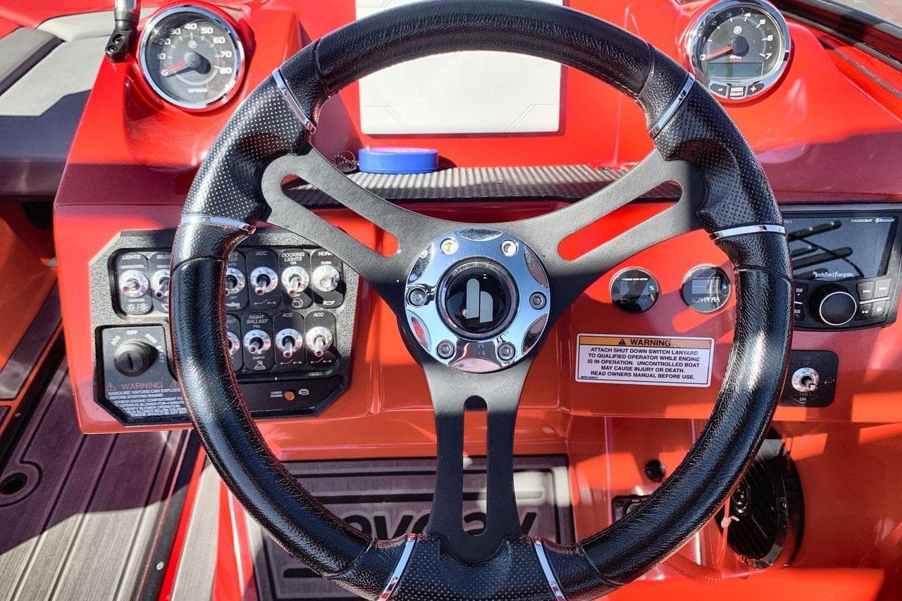 Steering wheel and dashboard of 2023 Heyday WT-2DC boat, featuring gauges and controls.